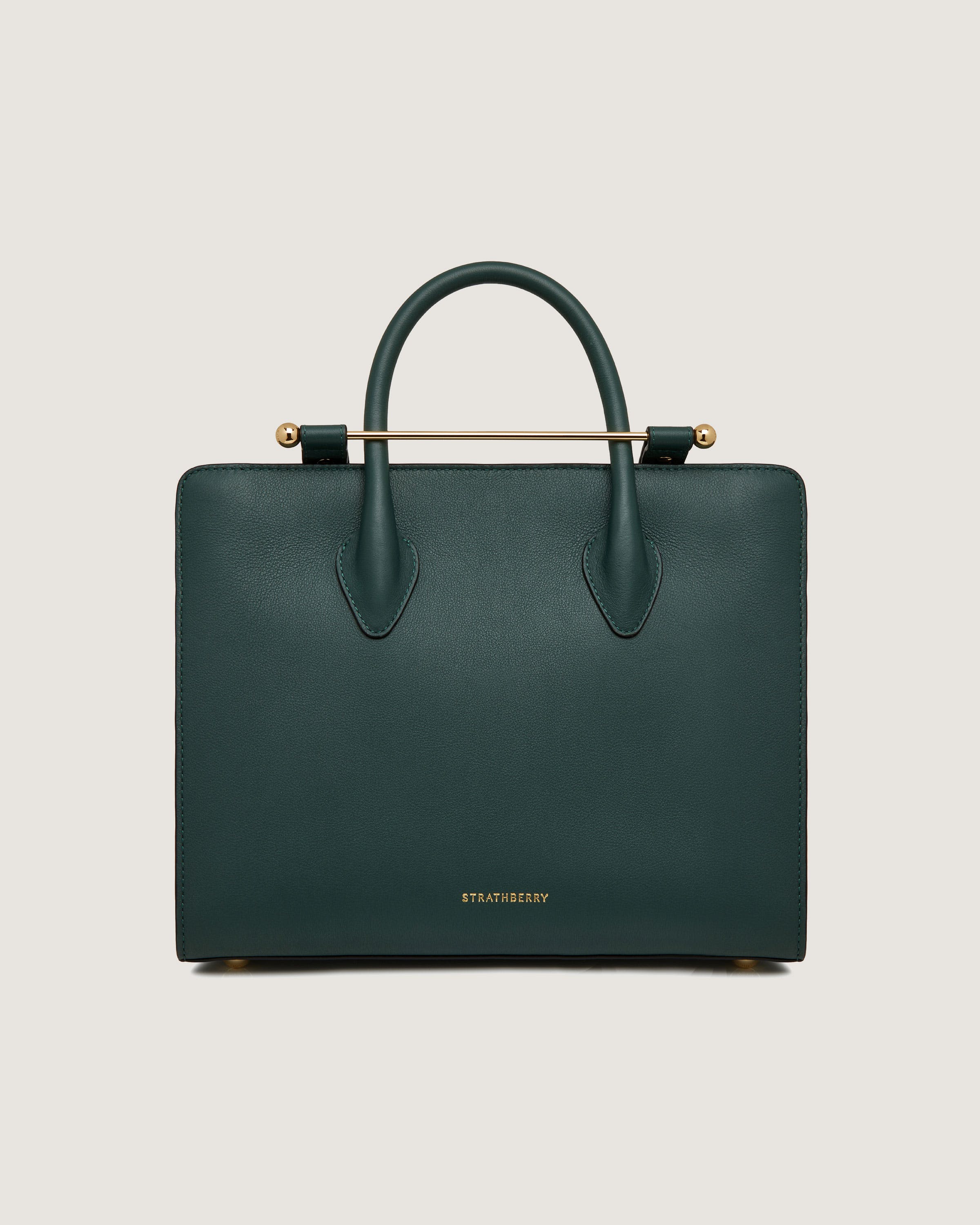 A green handbag with a gold handle