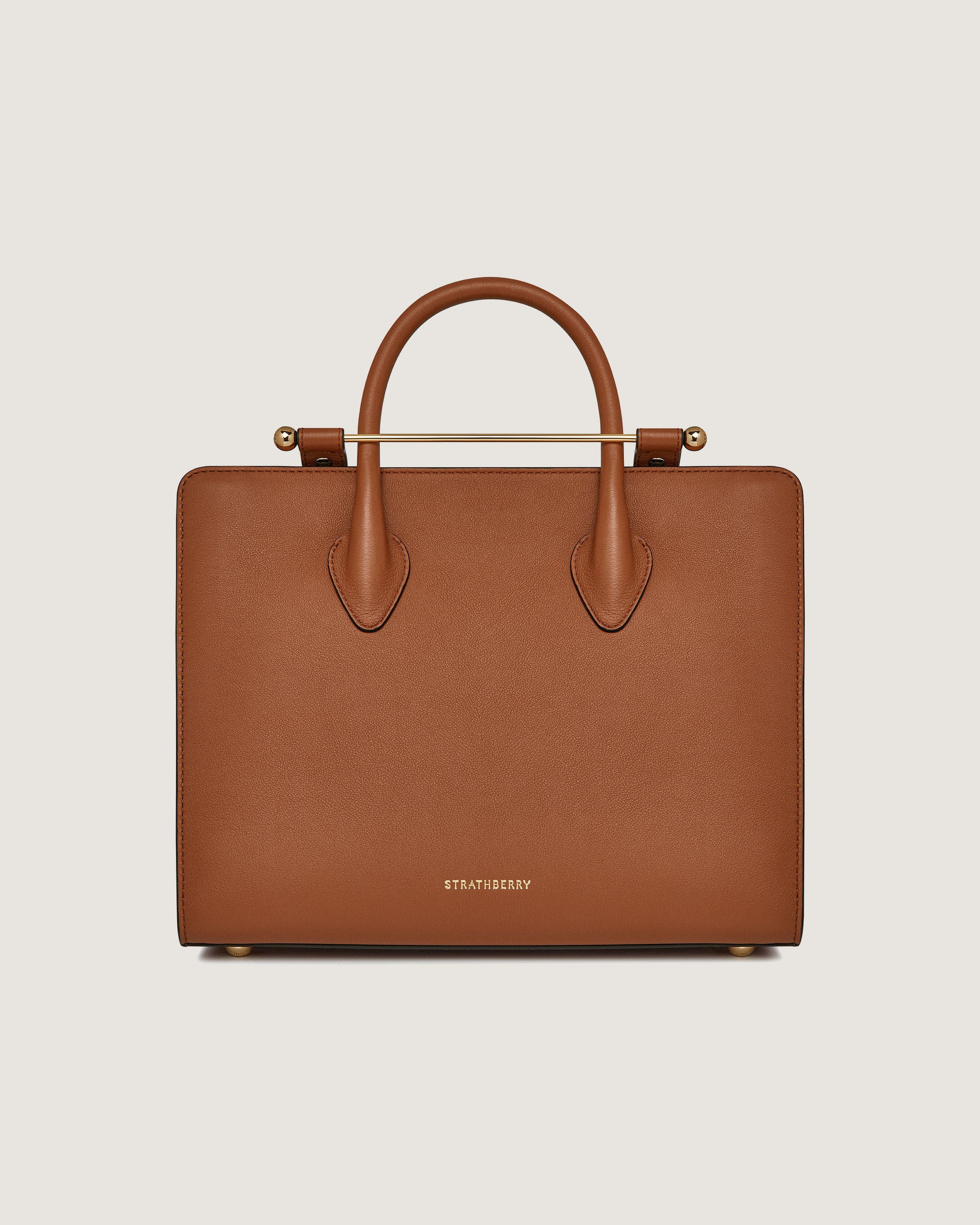 A tan leather briefcase with a handle