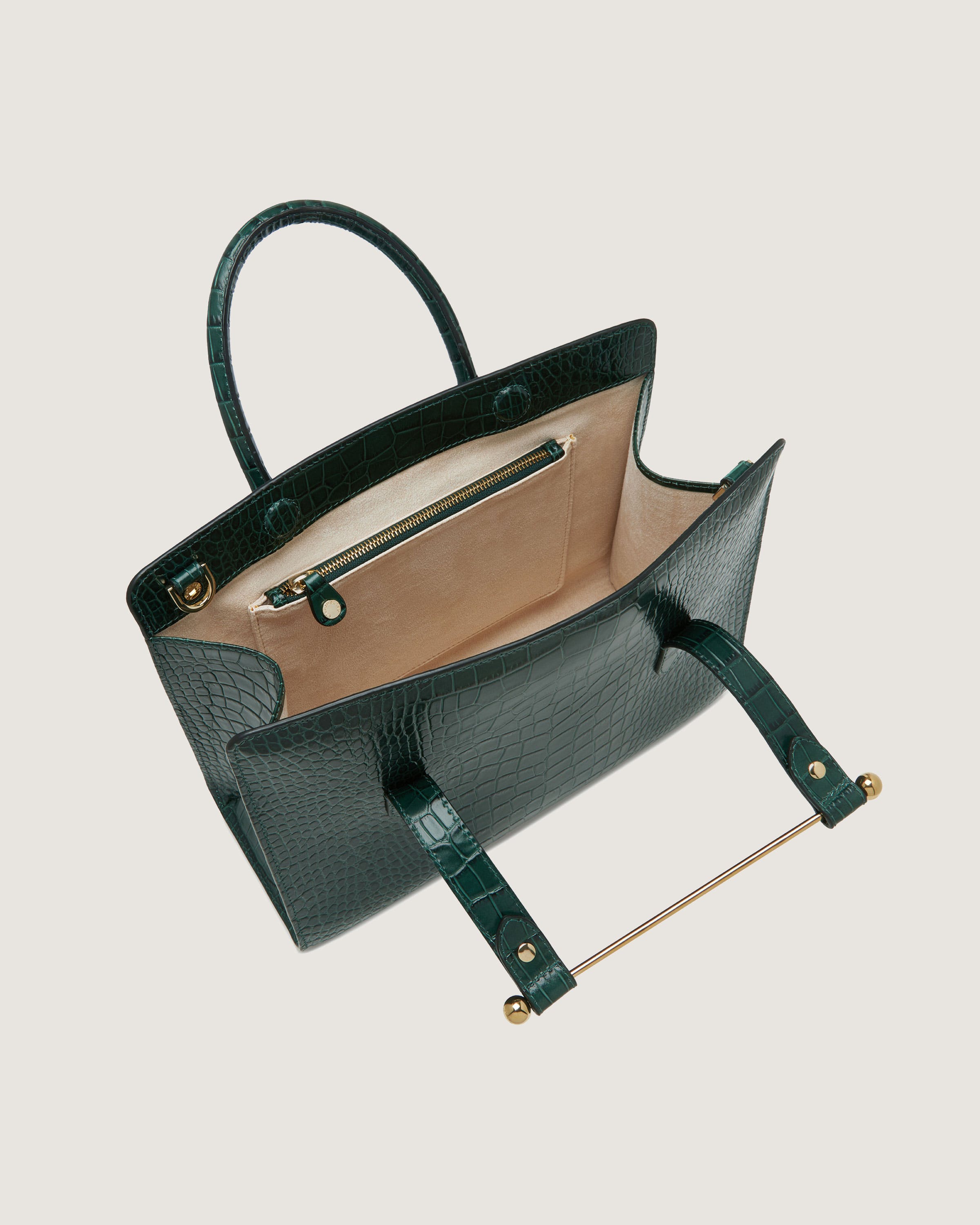 A handbag with a long handle and a long strap