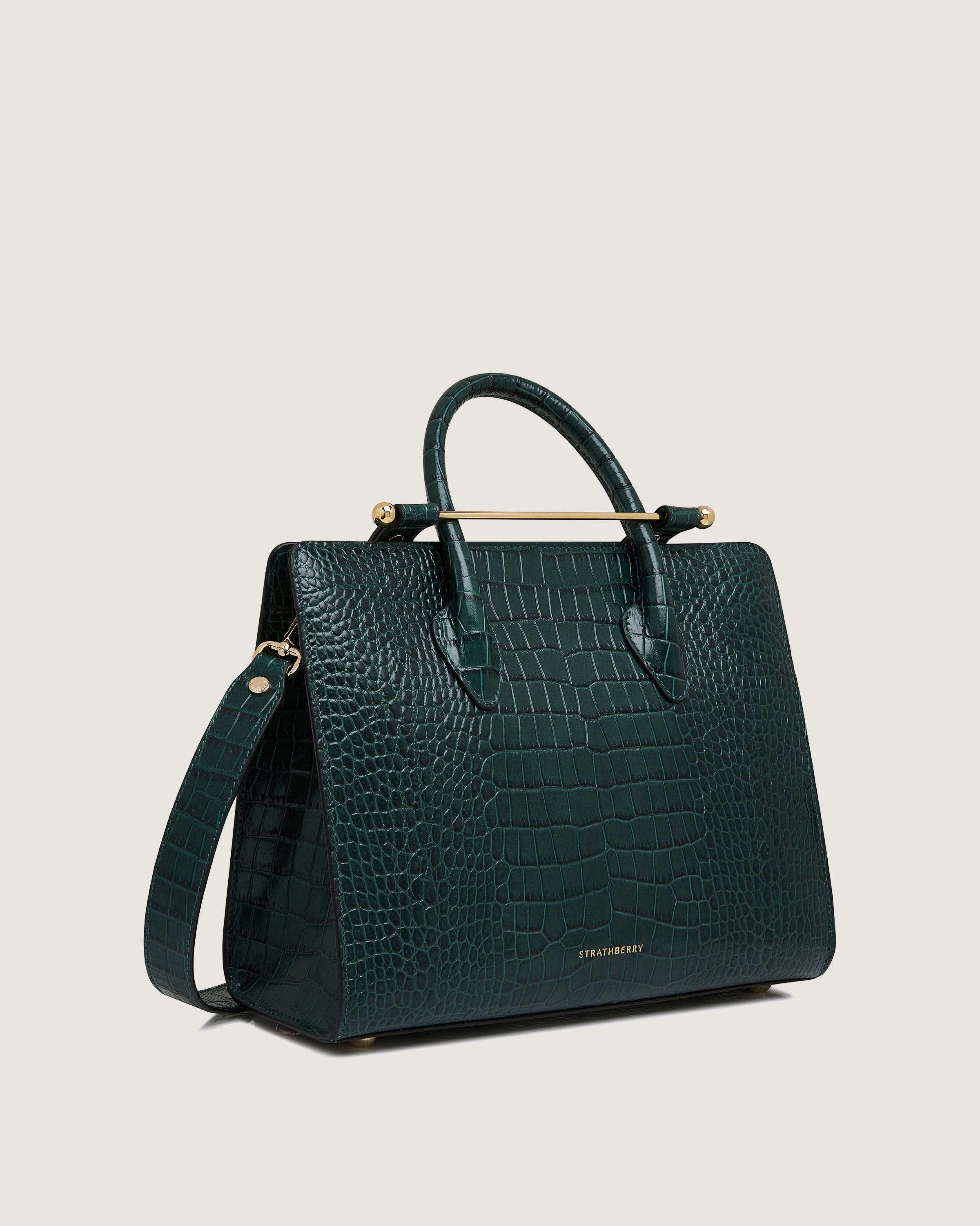 A green handbag on a white background