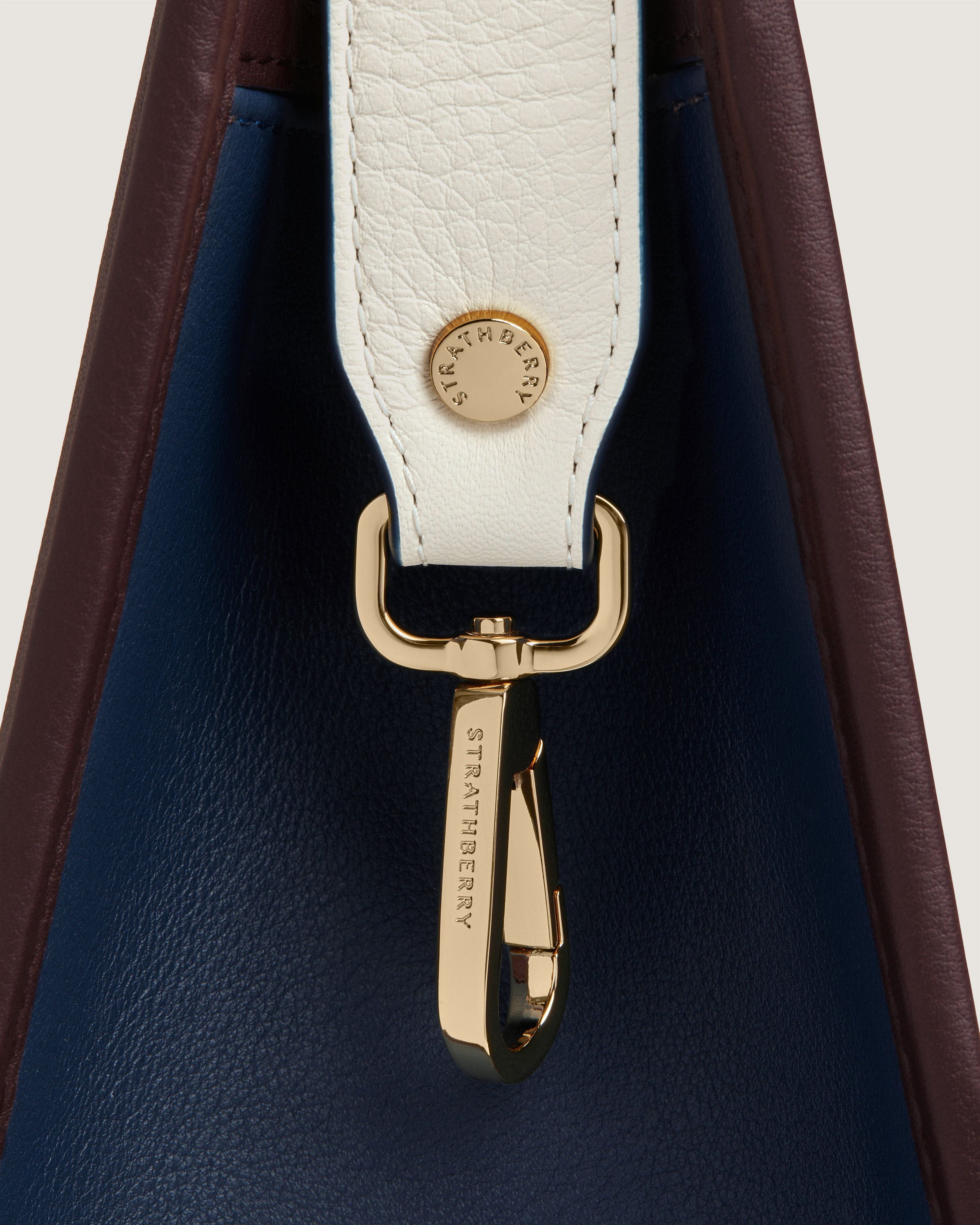 A close up of a white and blue purse