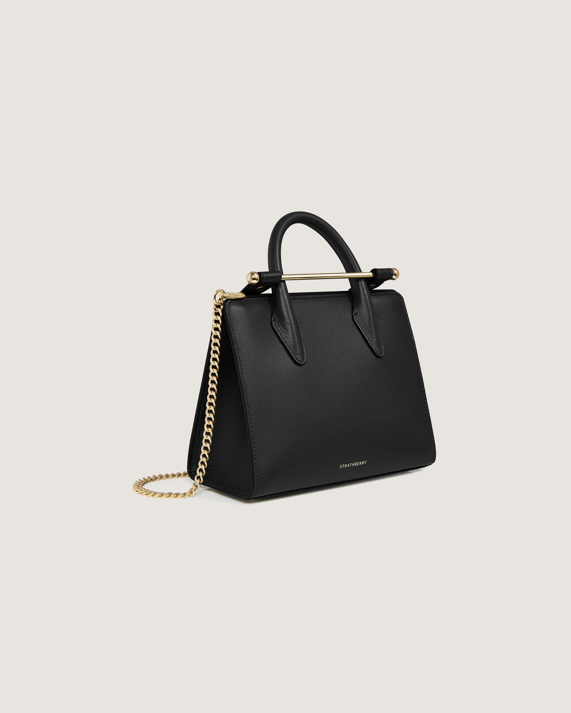 A black handbag with a gold chain