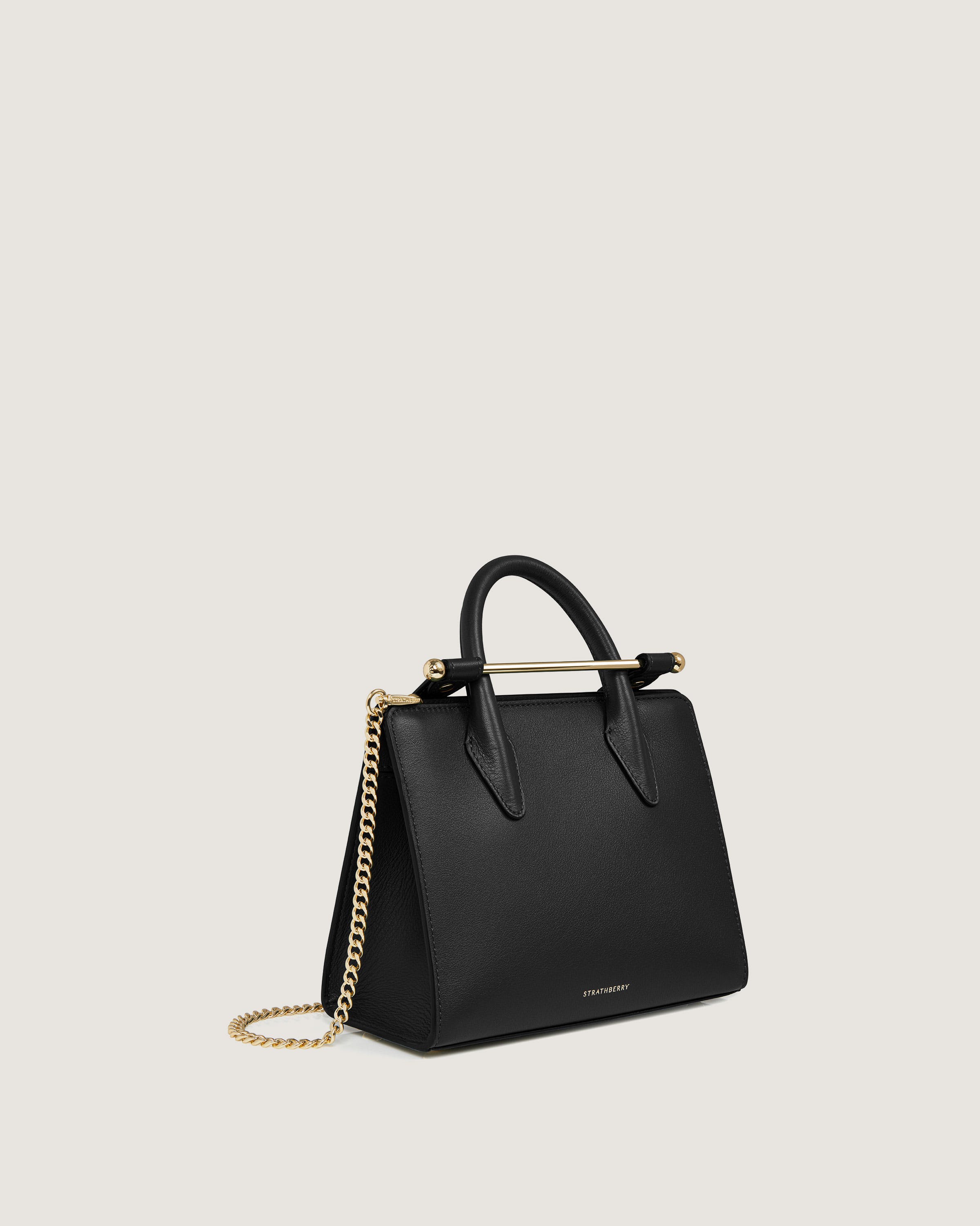 A black handbag with a gold chain