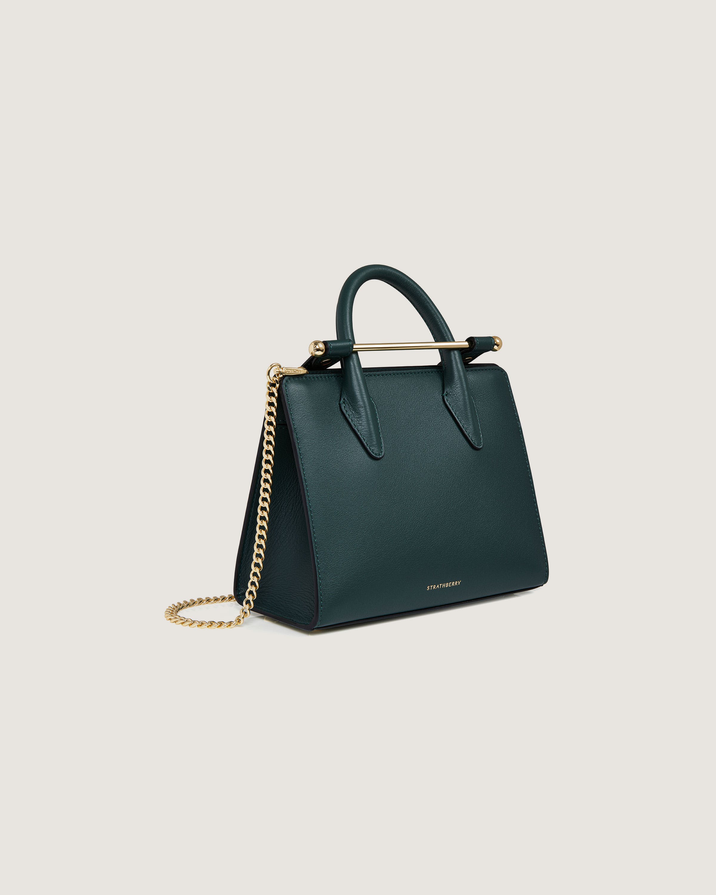 A green handbag with a gold chain