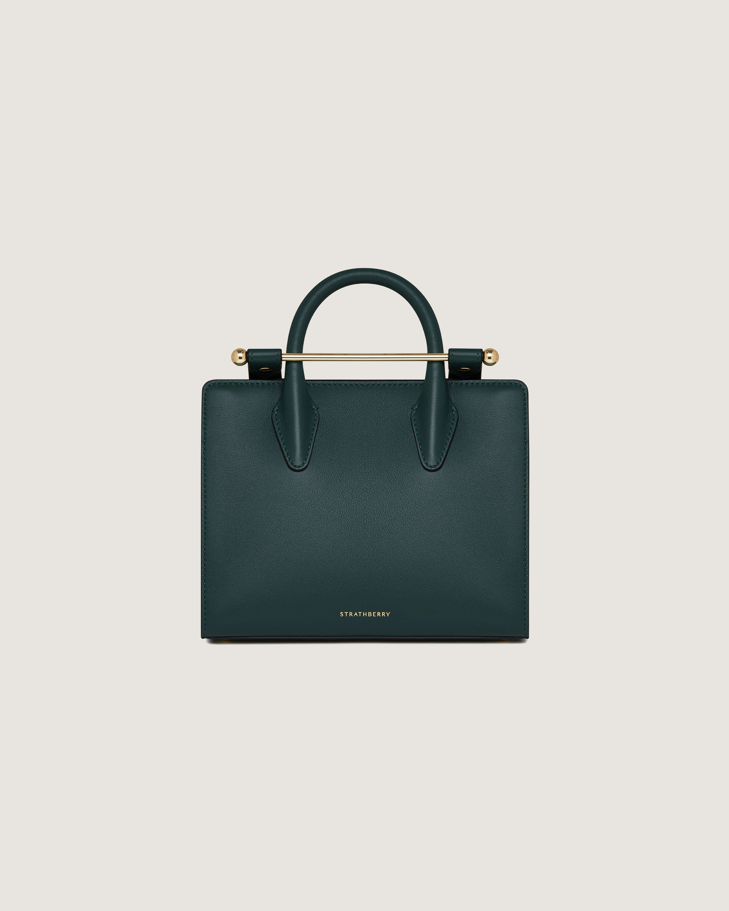 A green handbag with a gold handle