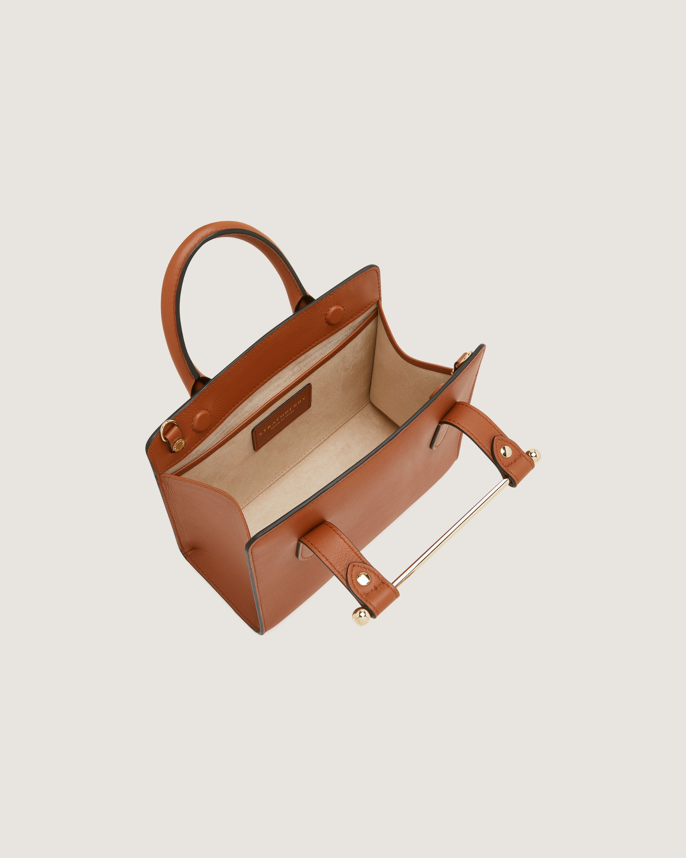 A brown leather handbag on a white background