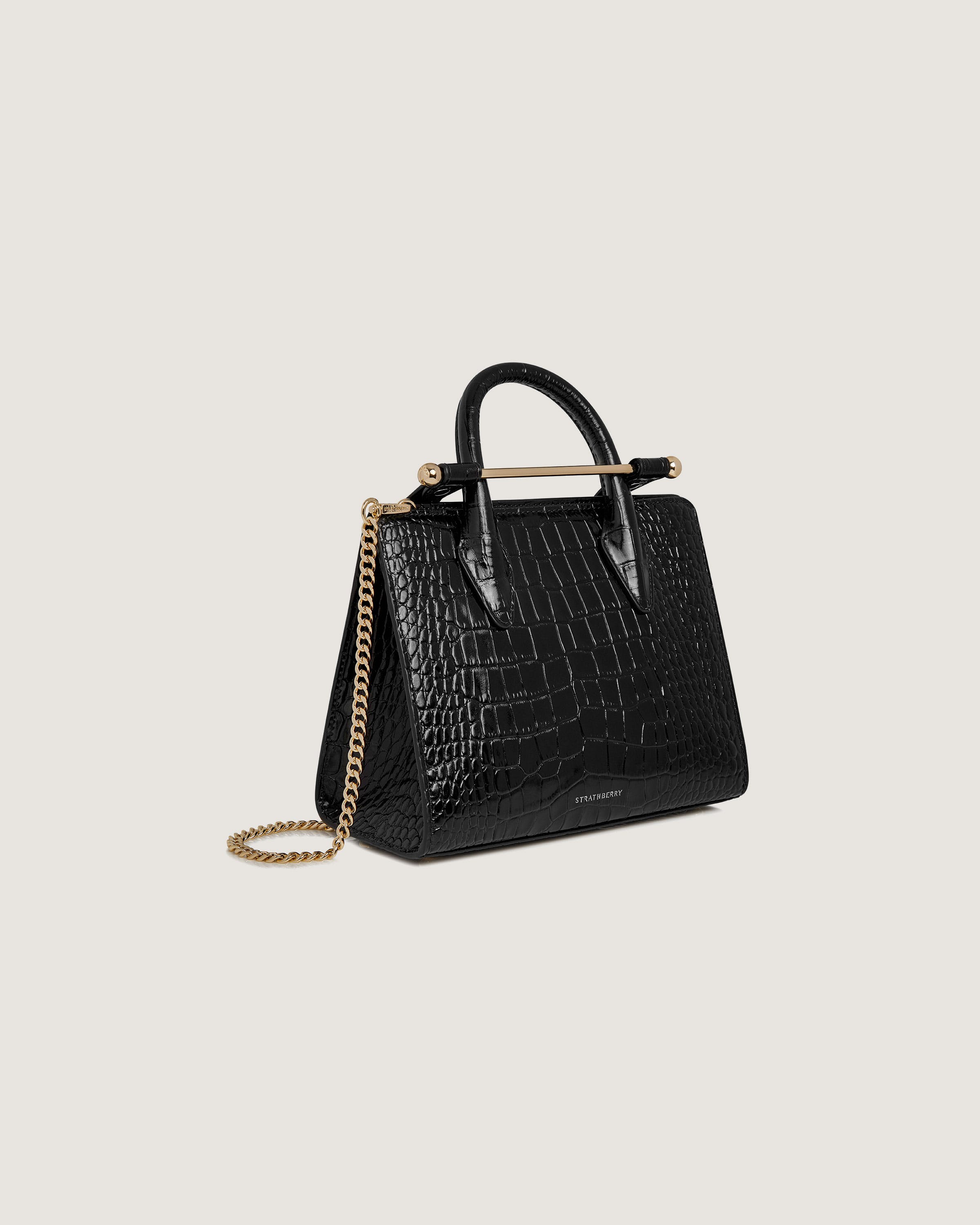 A black handbag with a gold chain