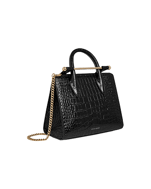 A black handbag on a green background