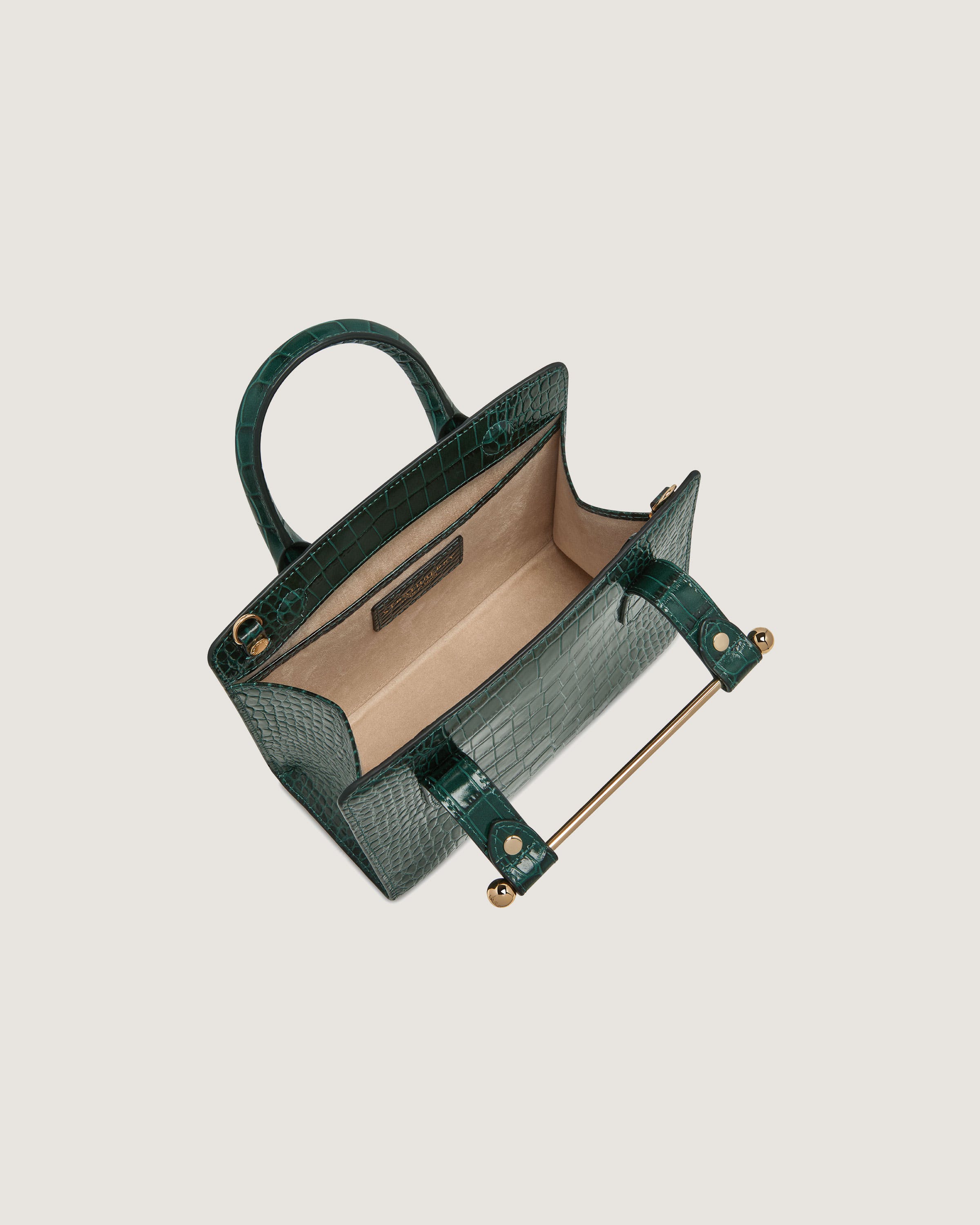 A green handbag with a handle on a white background