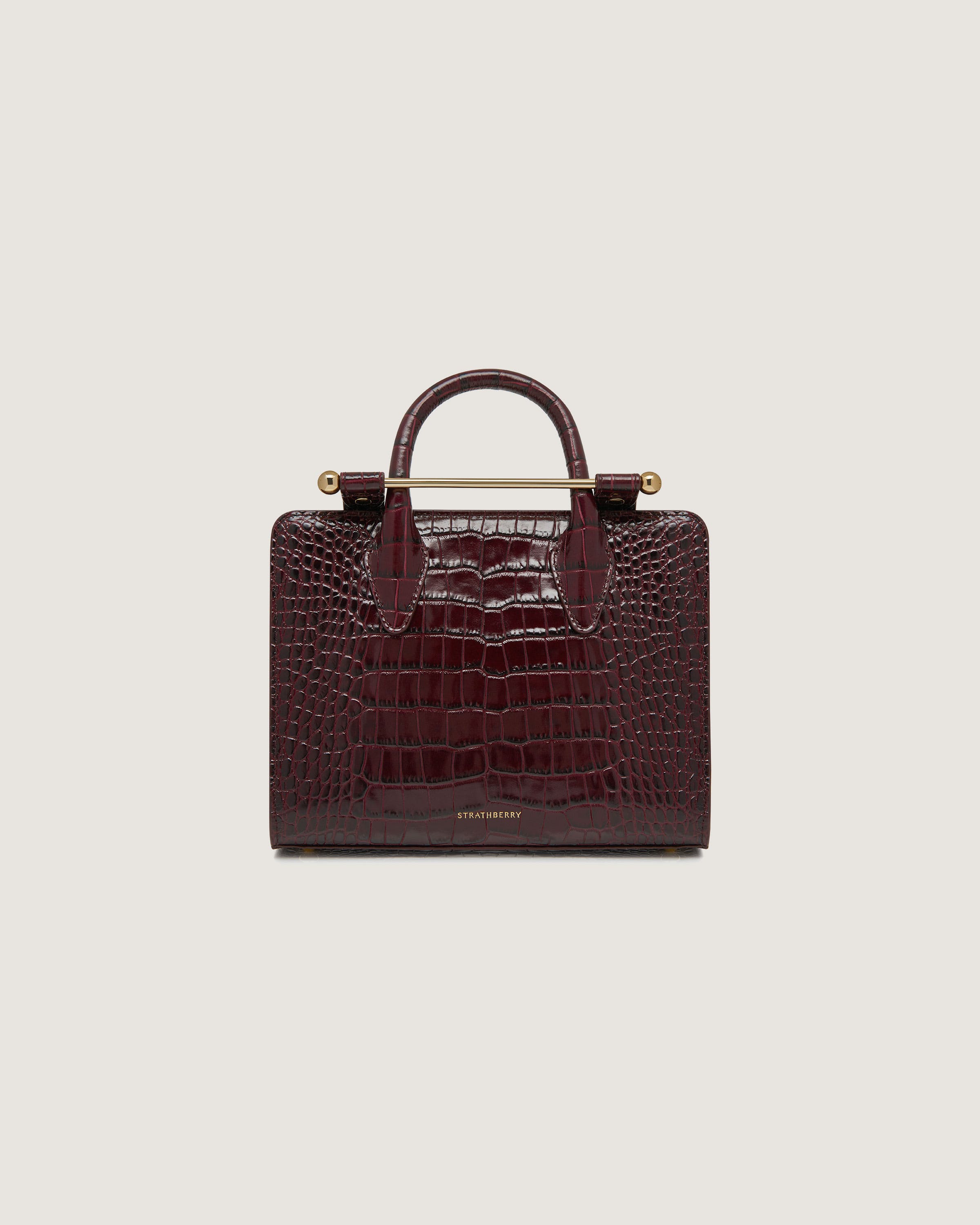 A brown crocodile - embossed leather bag