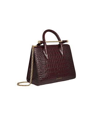 A brown crocodile skin handbag with a gold chain