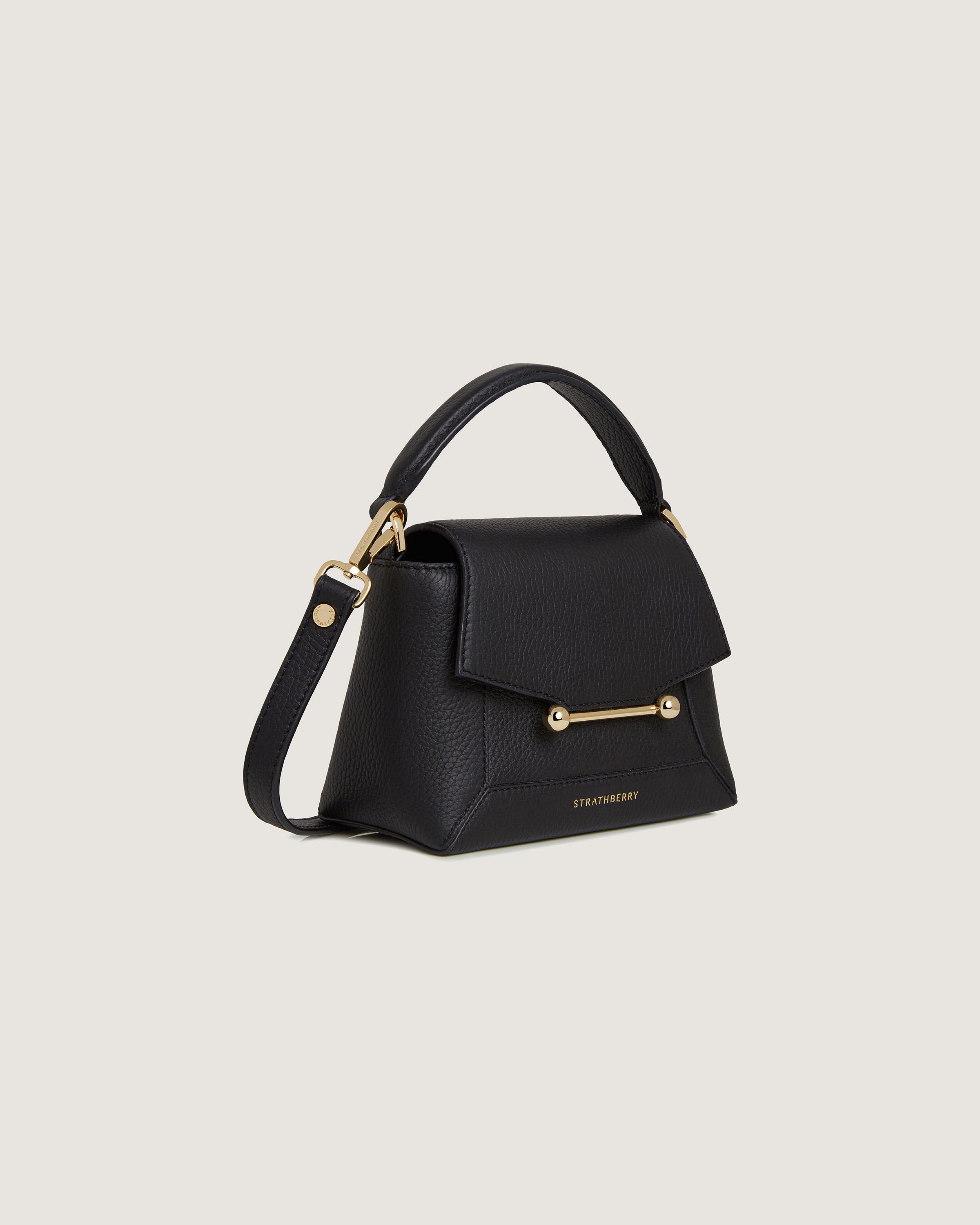 A black handbag with a gold handle