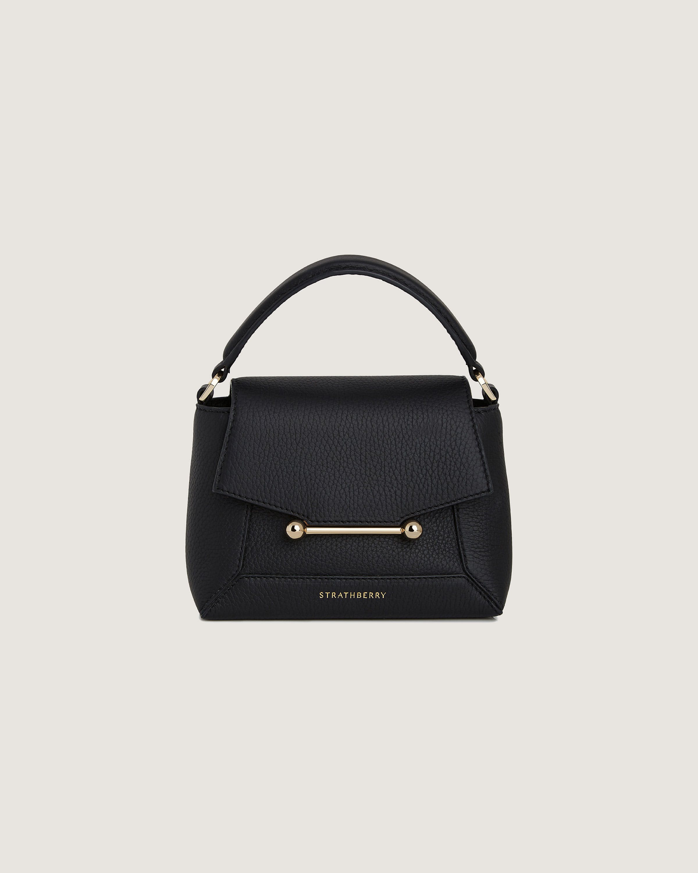 A black handbag with a gold handle