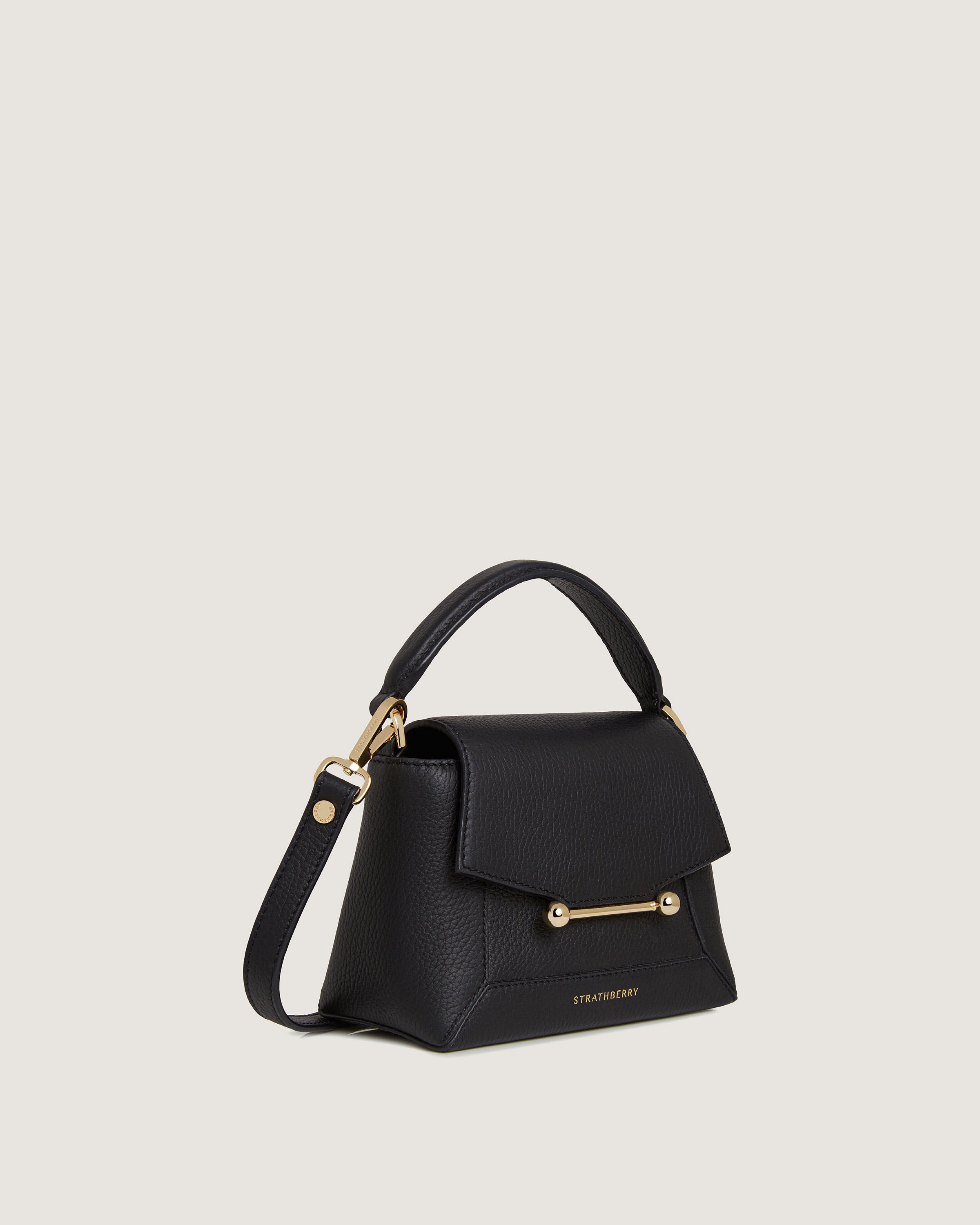 A black handbag with a gold handle