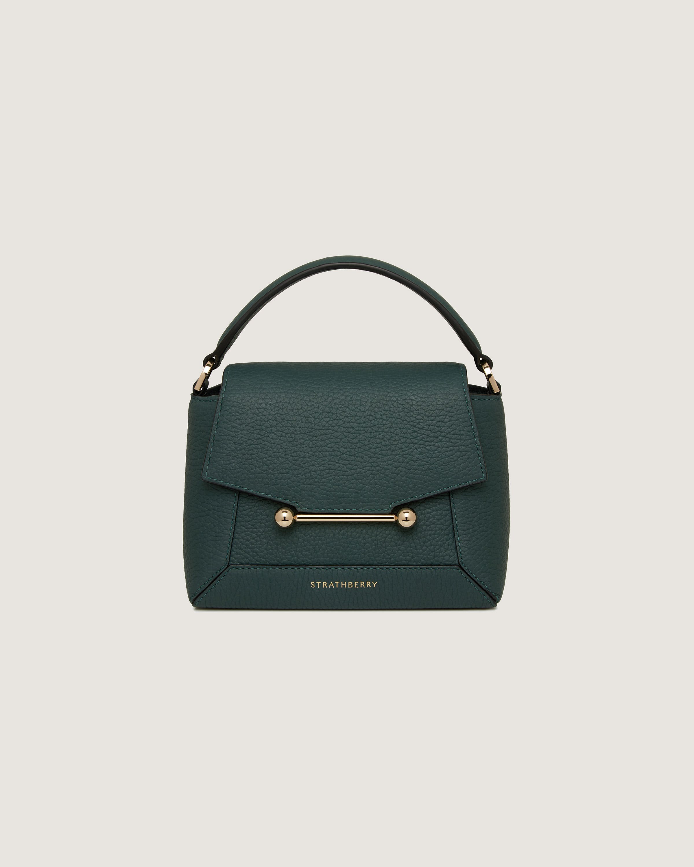 A green handbag with a gold handle