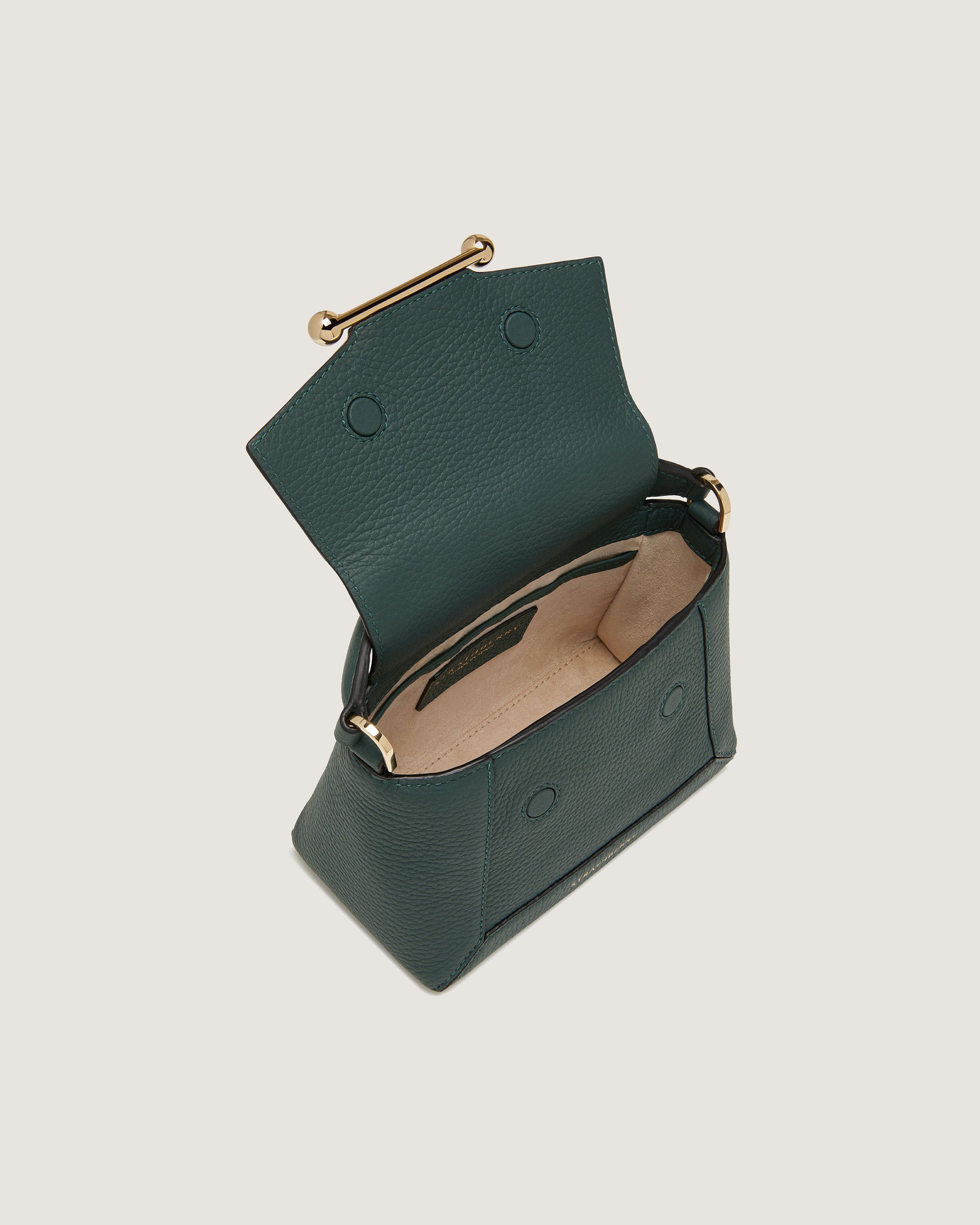 A small green purse with a gold handle