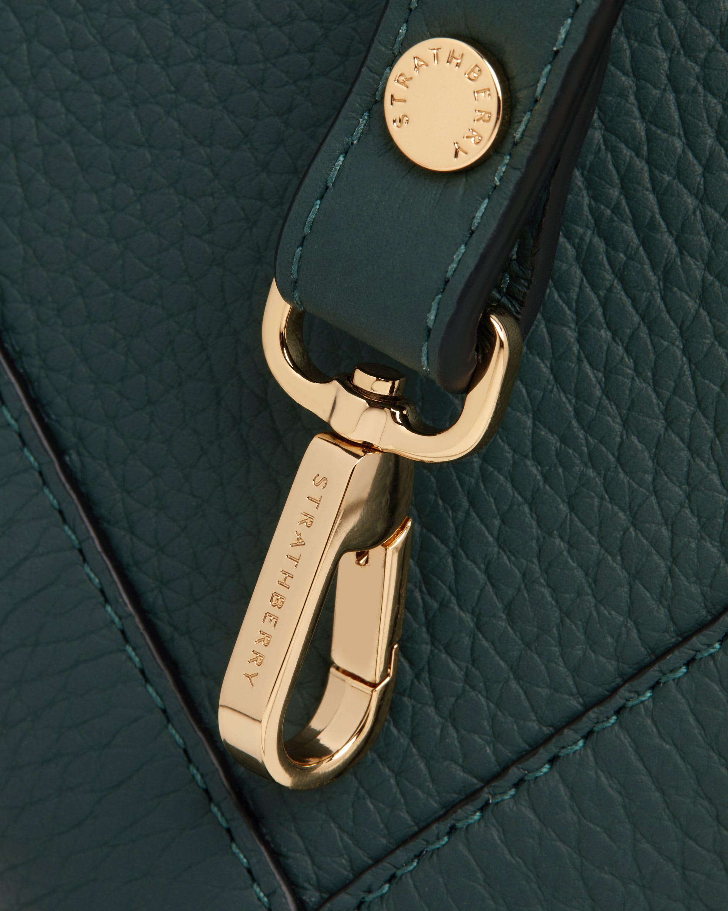 A close up of a green purse with a gold buckle