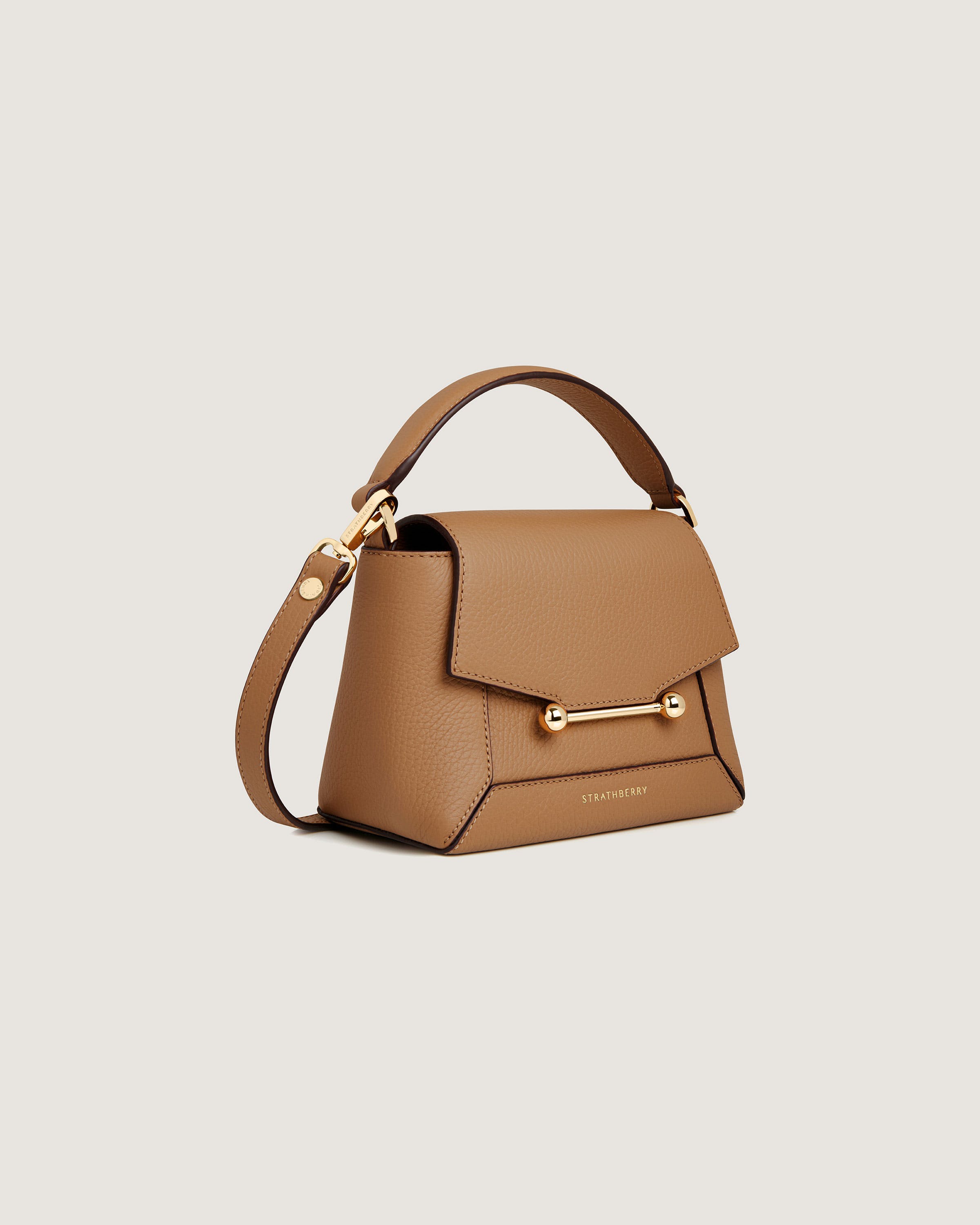 A brown handbag with a gold handle