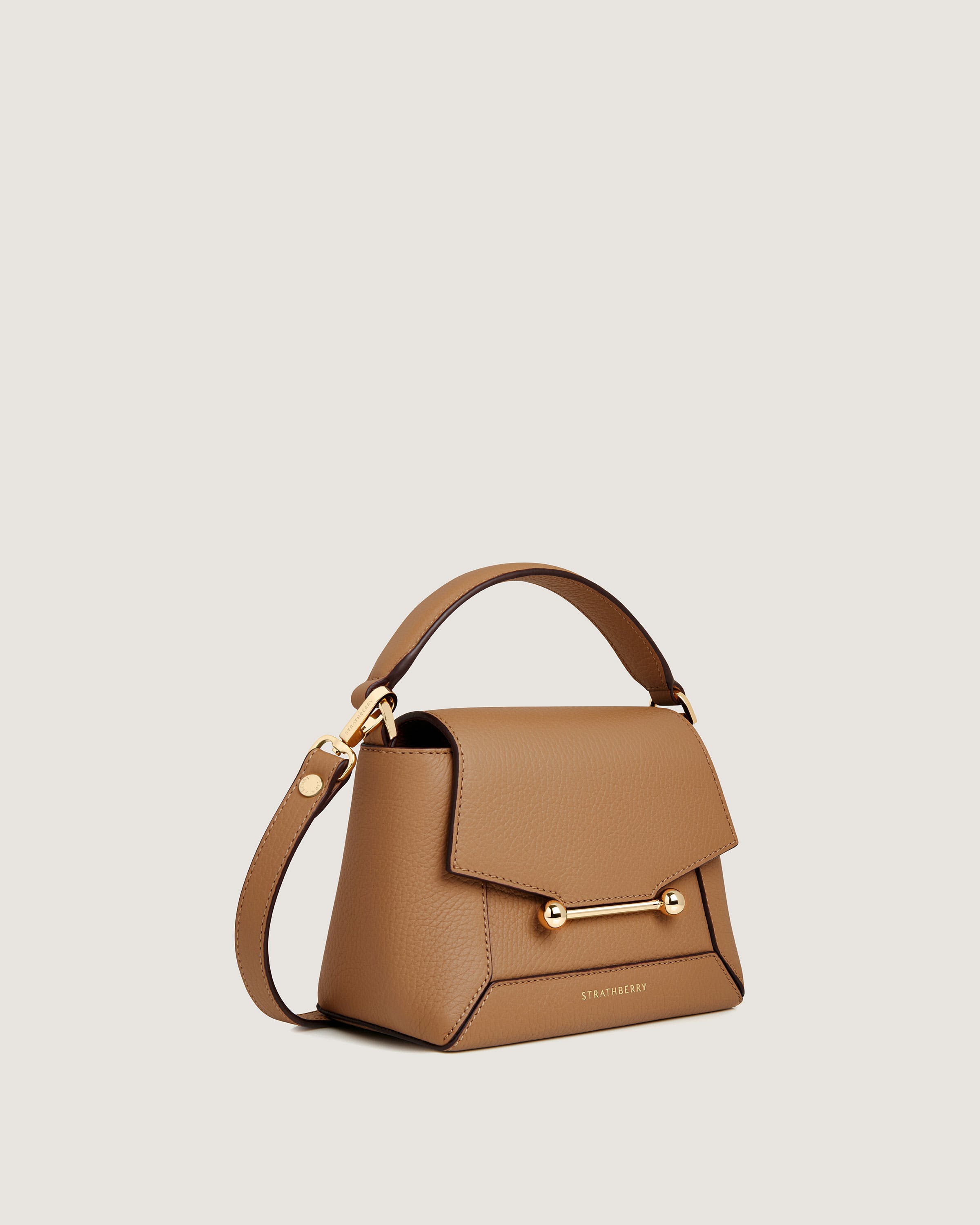 A brown handbag with a gold handle