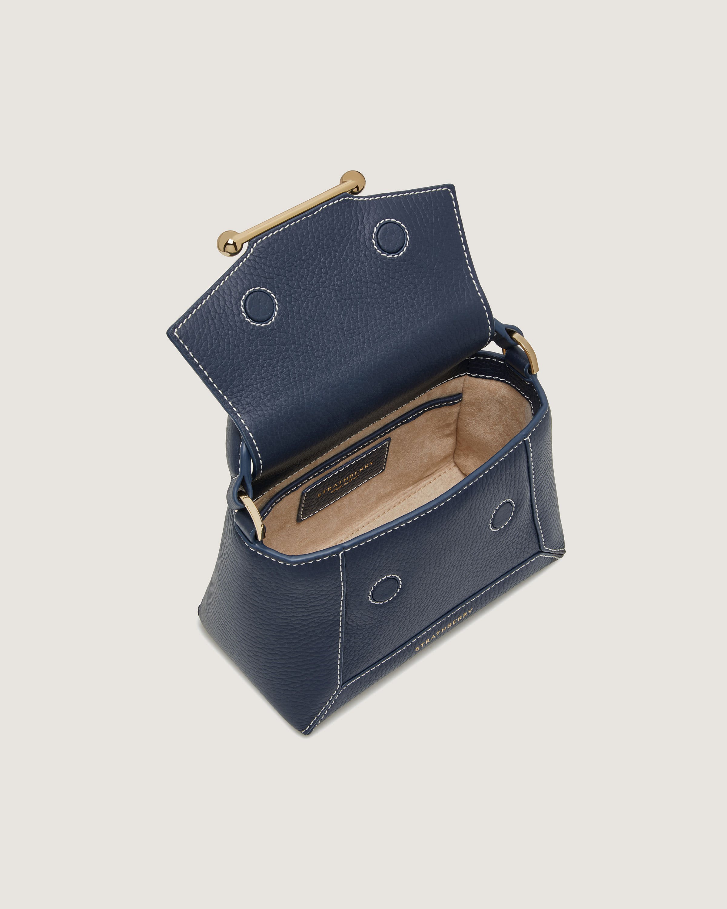 A small blue purse with a gold handle