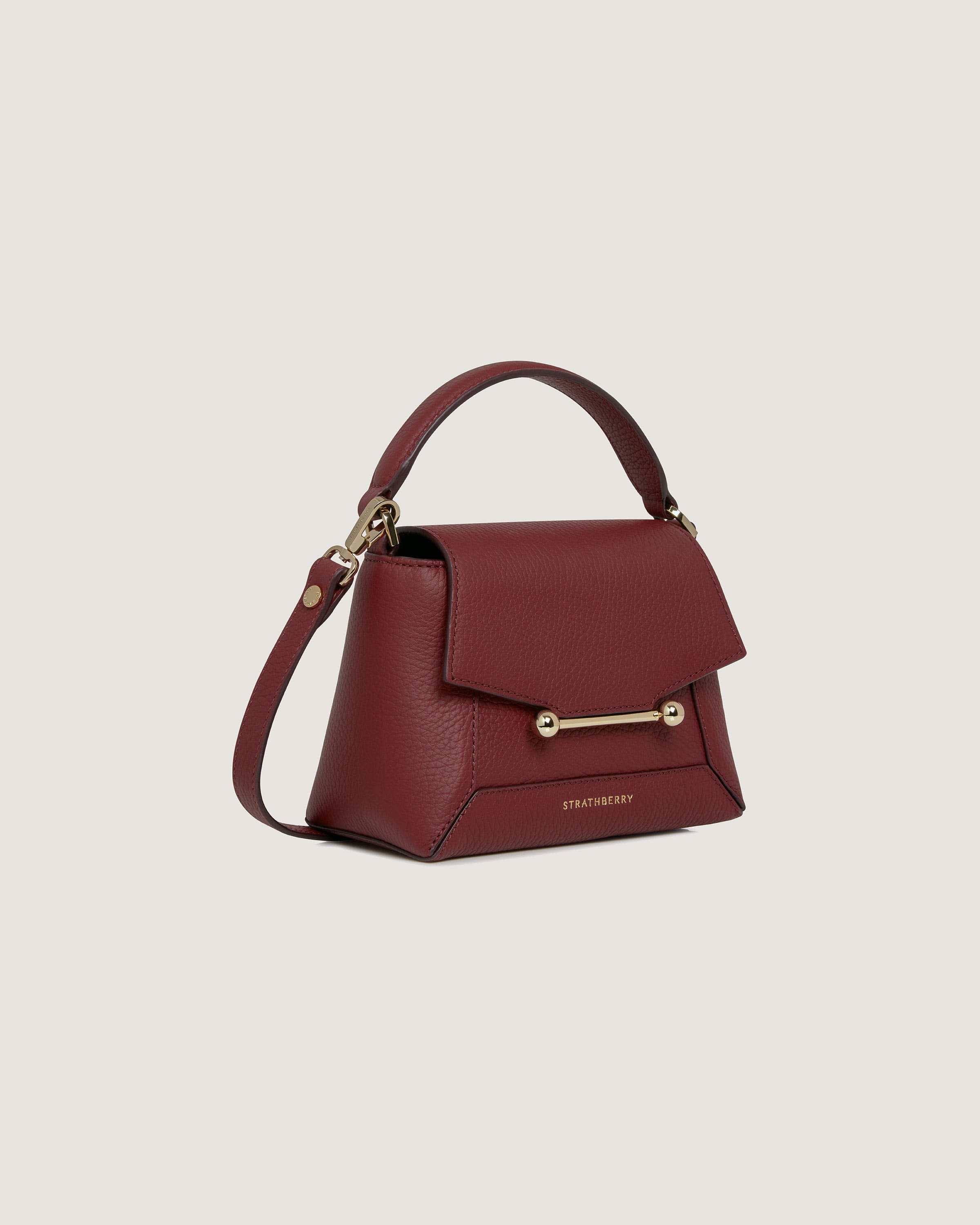 A red handbag with a gold handle