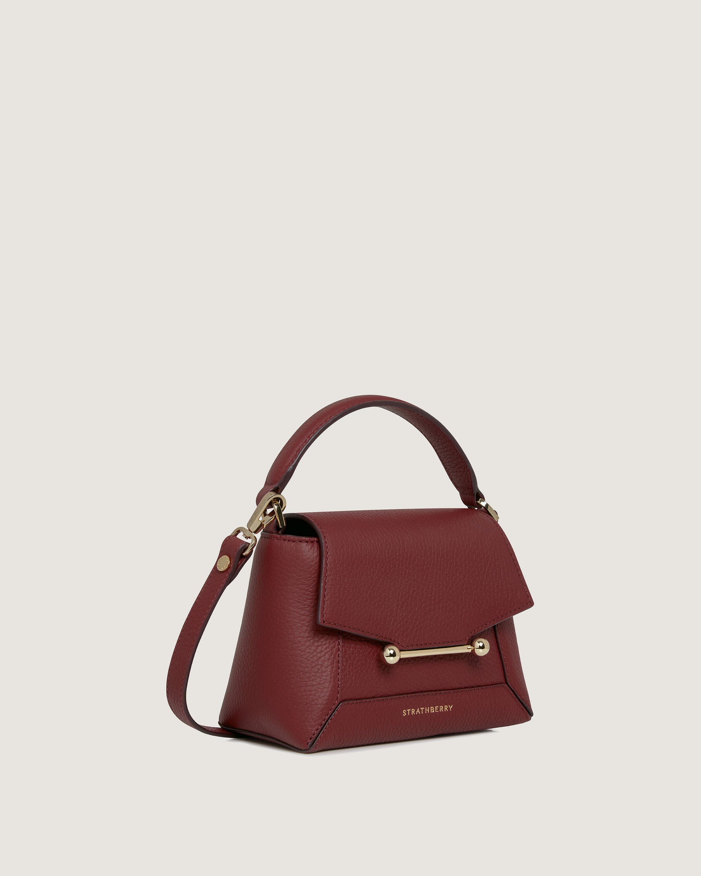 A red handbag with a gold handle