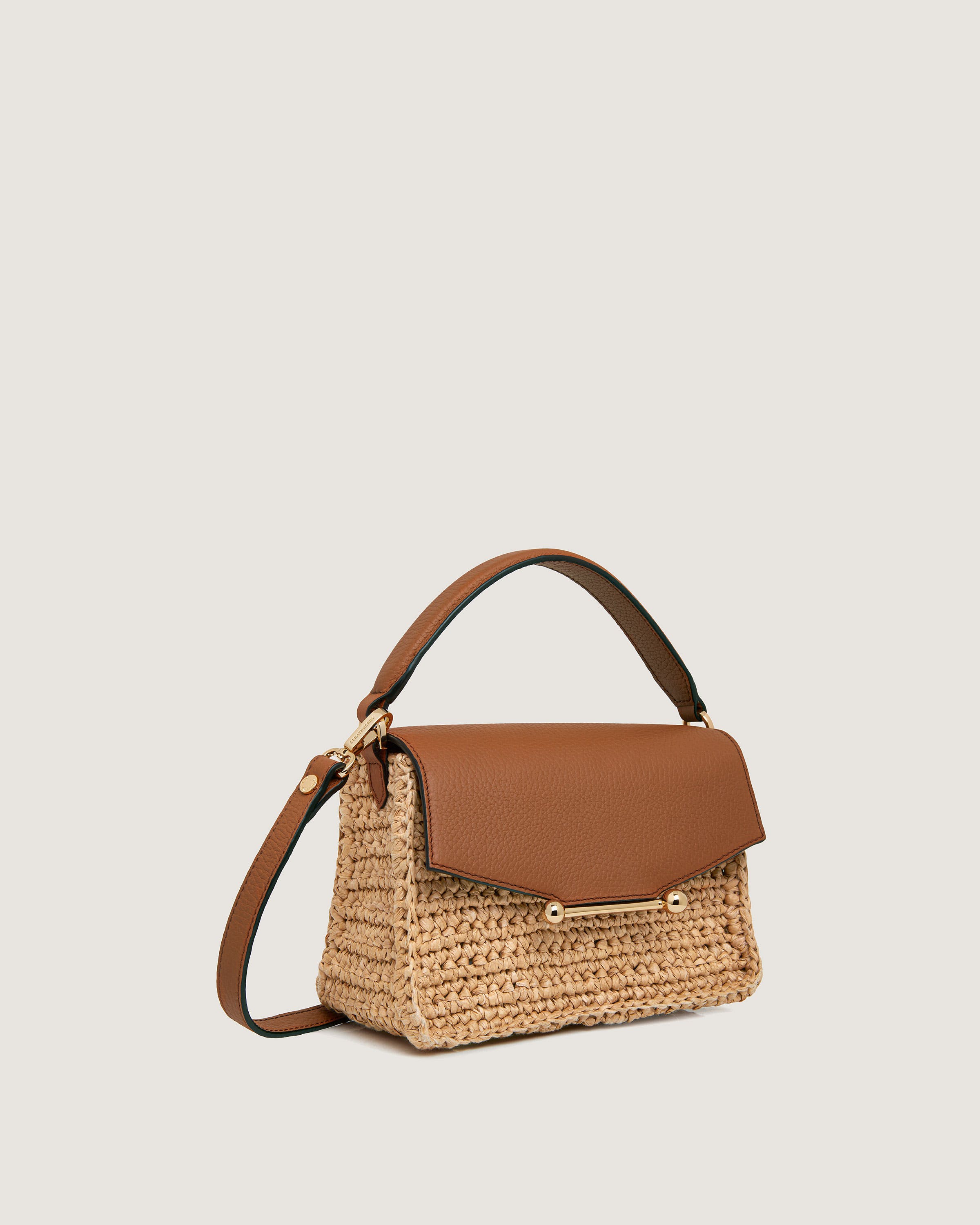 A brown and tan handbag on a white background