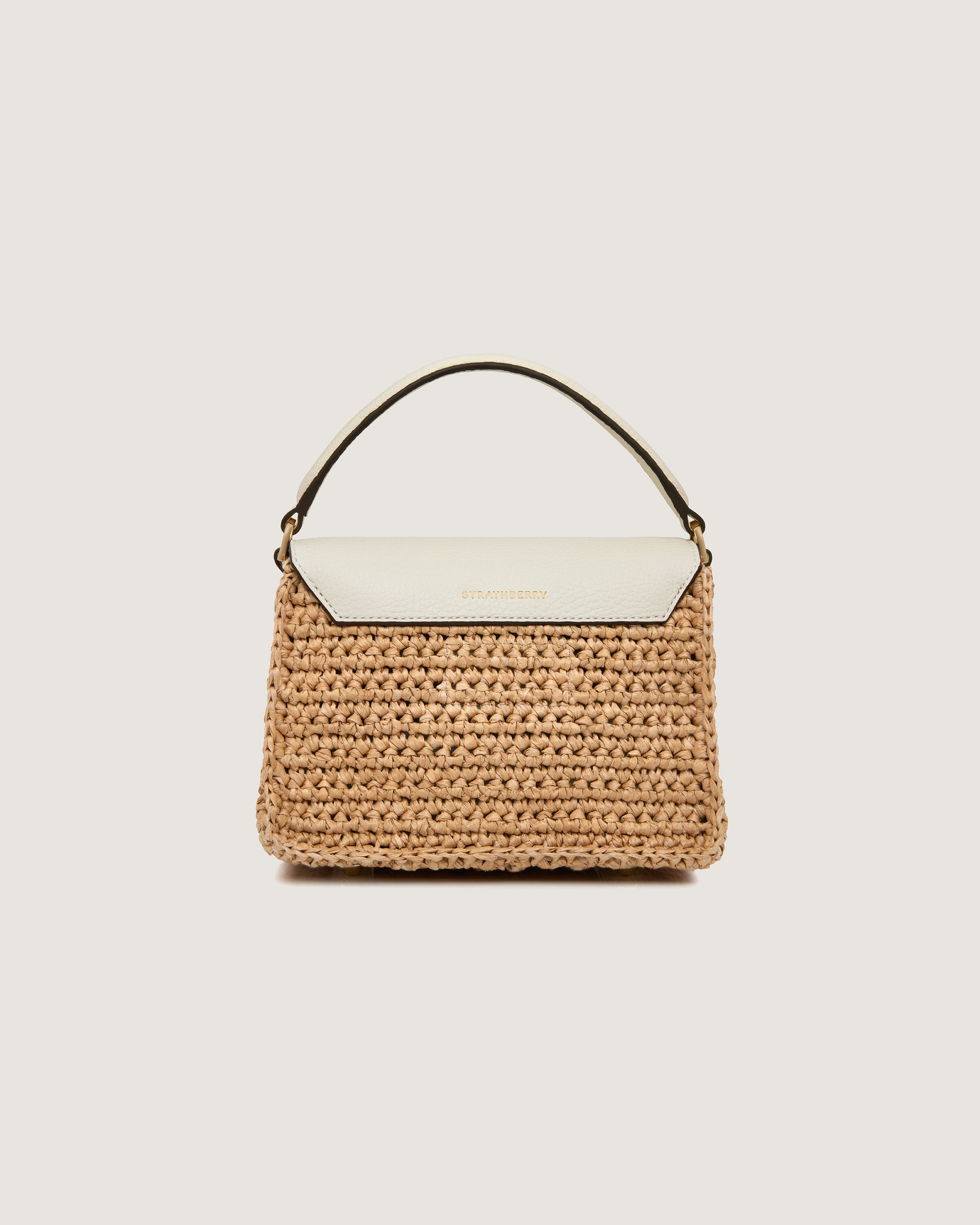 A straw bag with a white handle