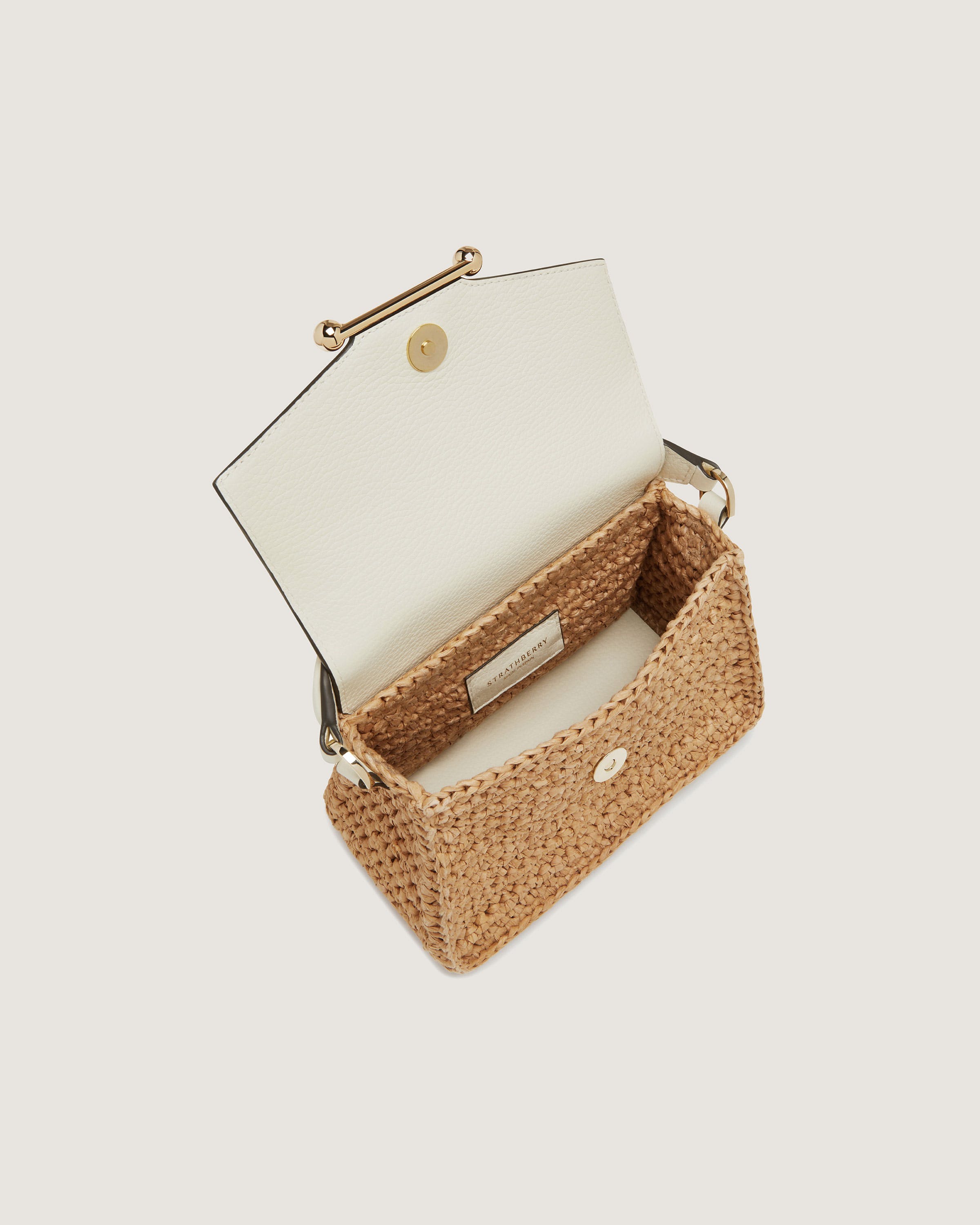 A white and tan purse with a handle