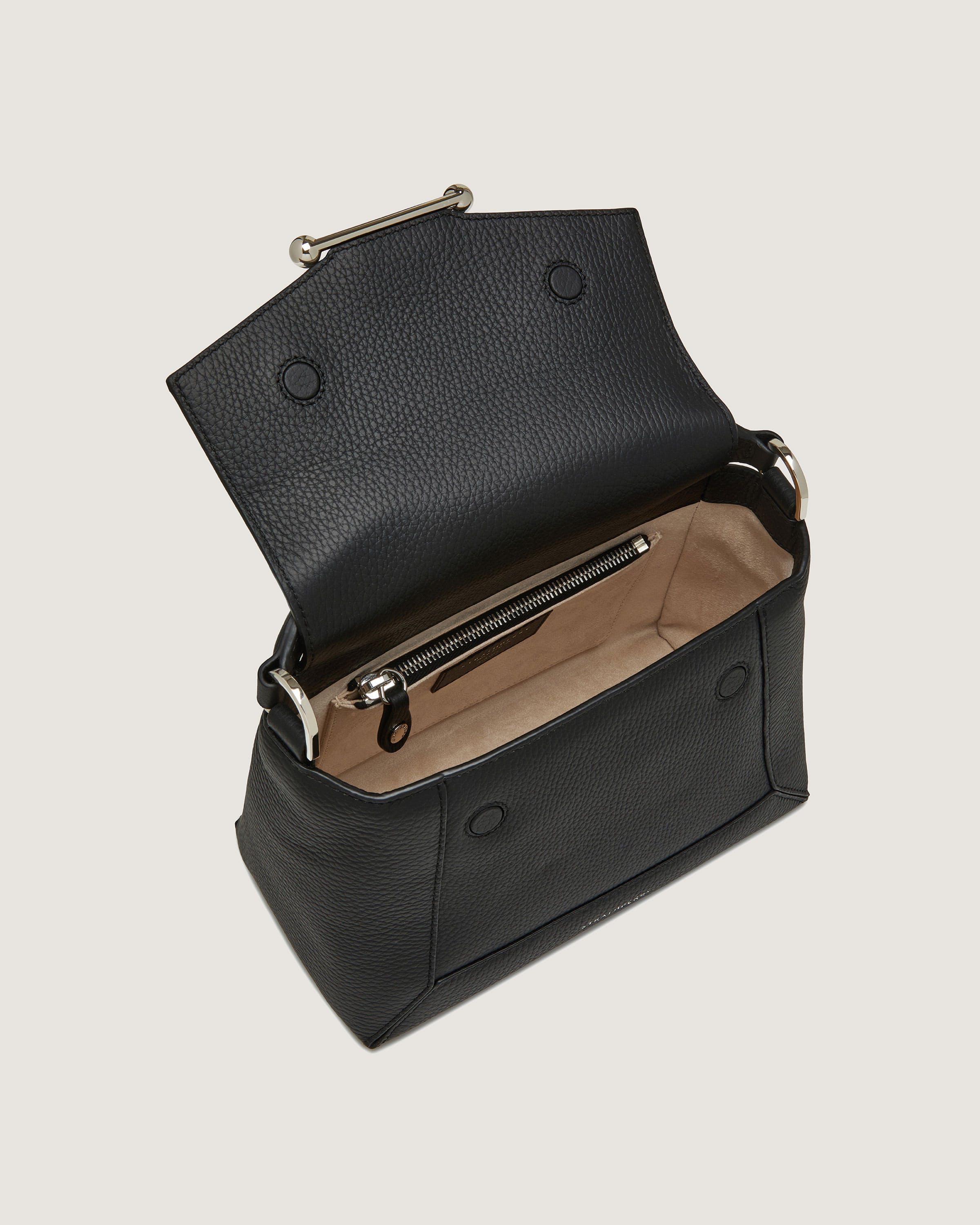 A black leather purse with a zippered compartment