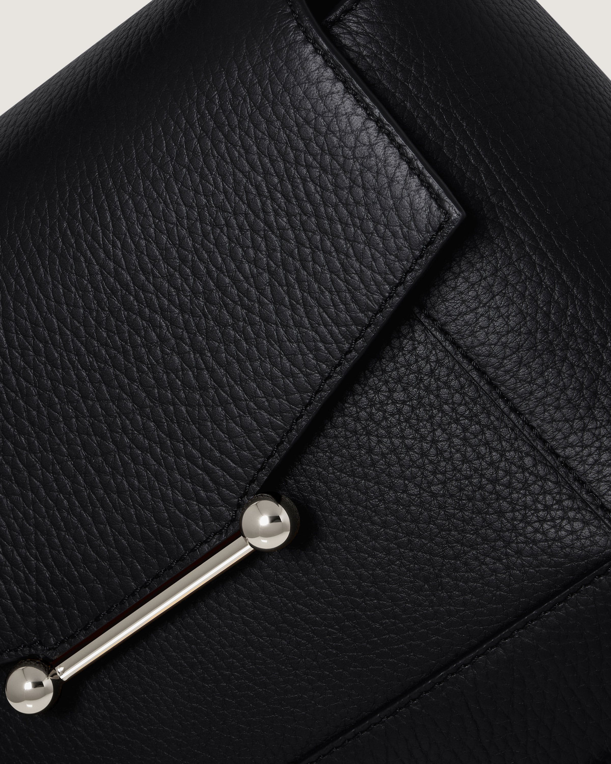 A close up of a black leather purse