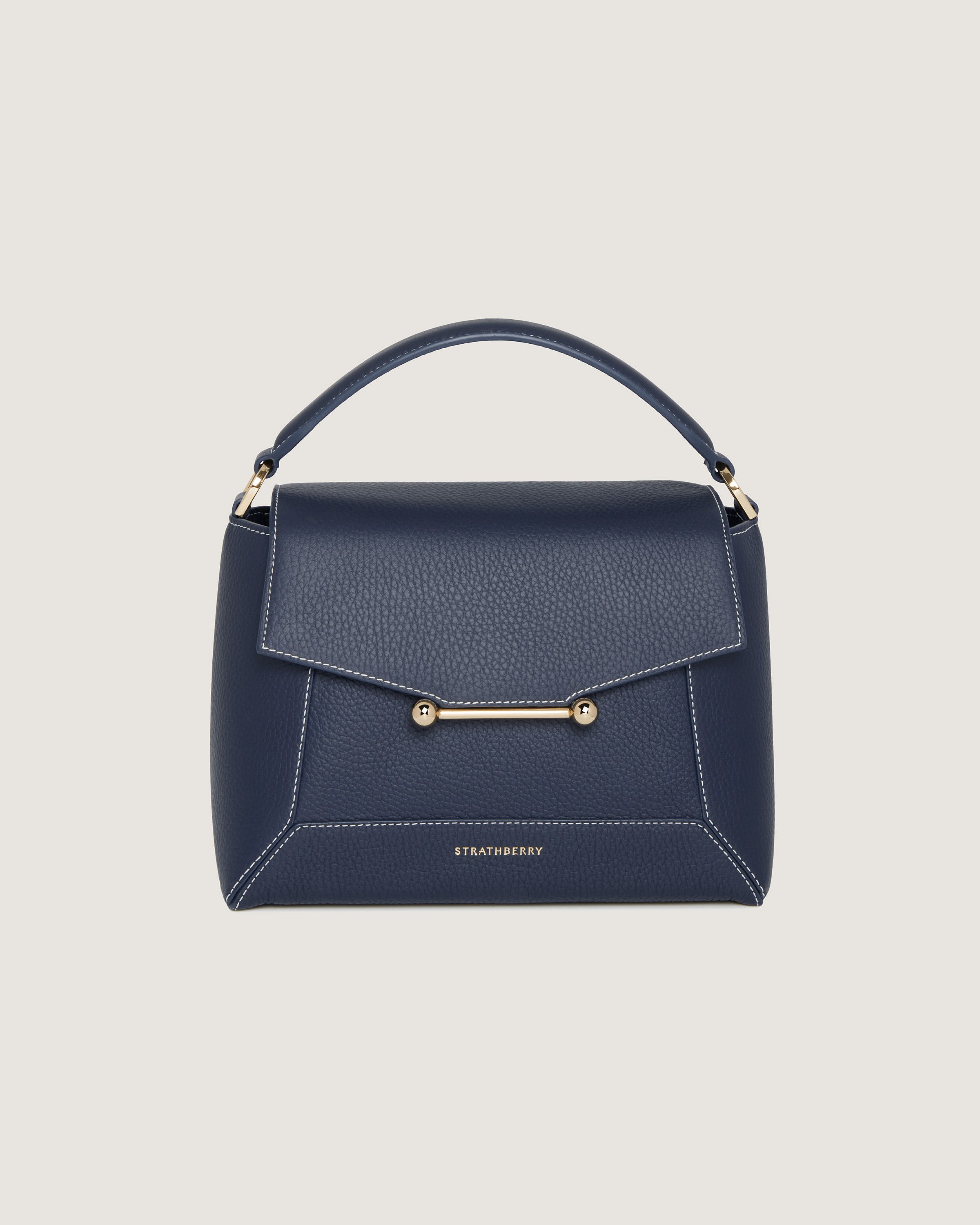 A blue handbag with a gold handle