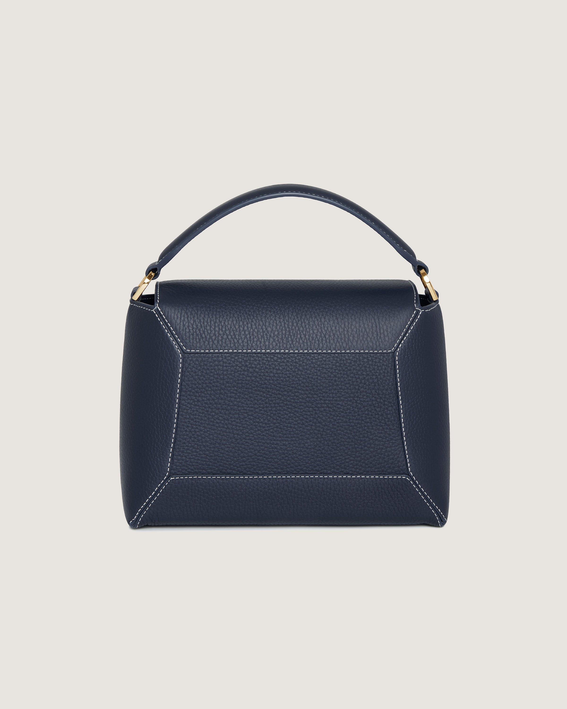 A blue handbag with a gold handle