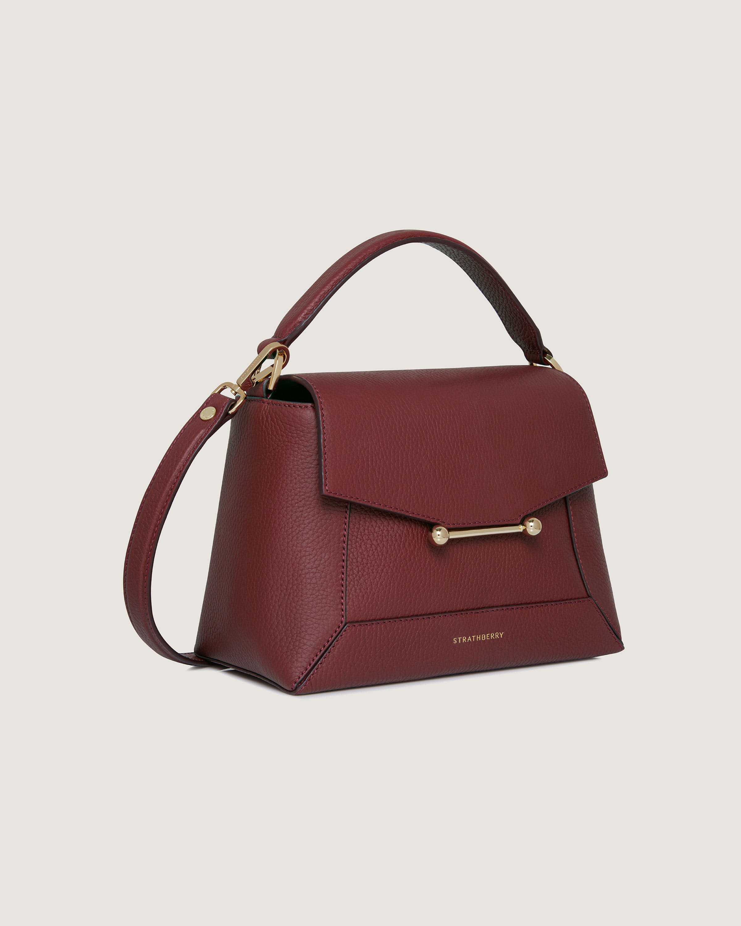 A red handbag with a gold handle