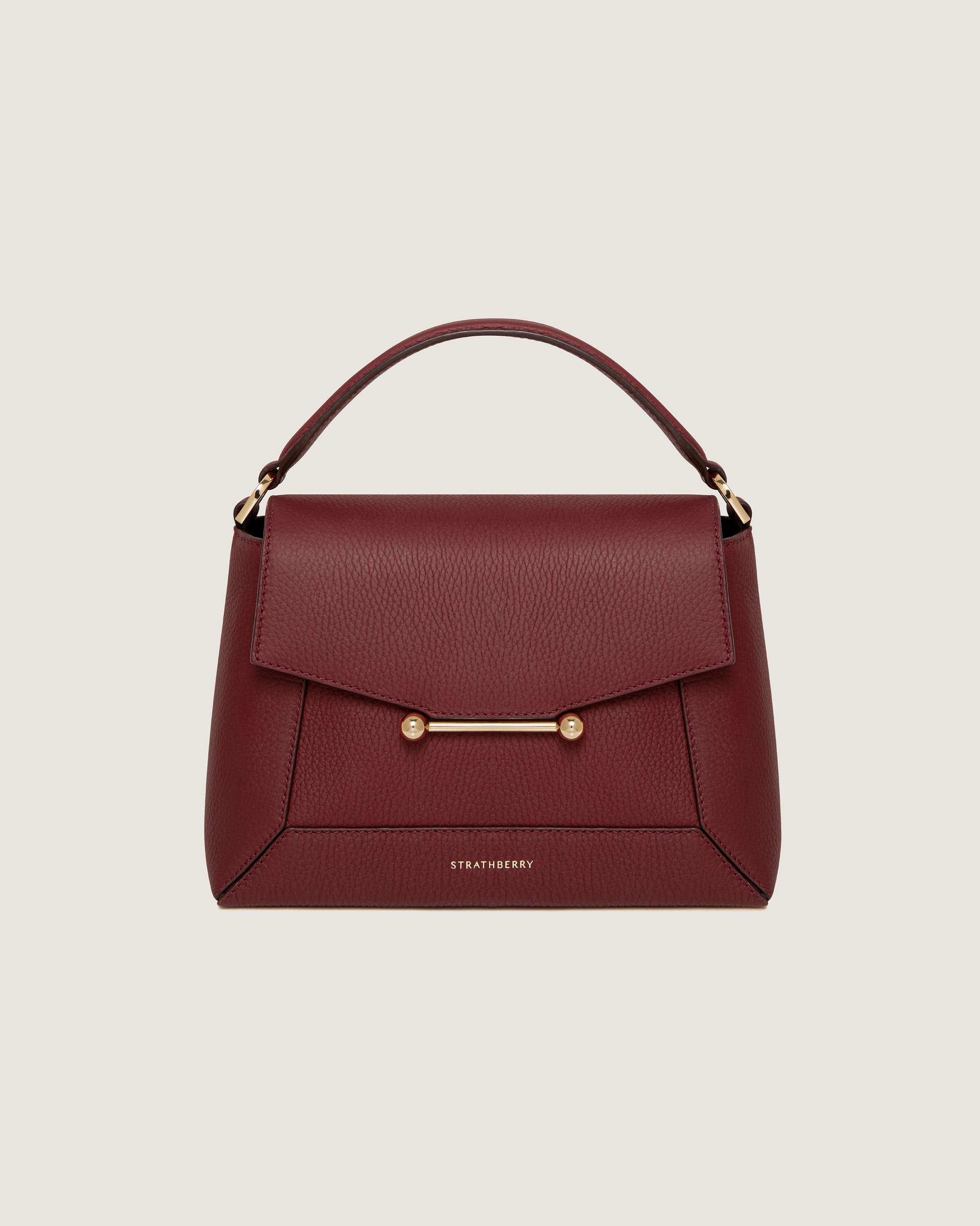 A red handbag with a gold handle