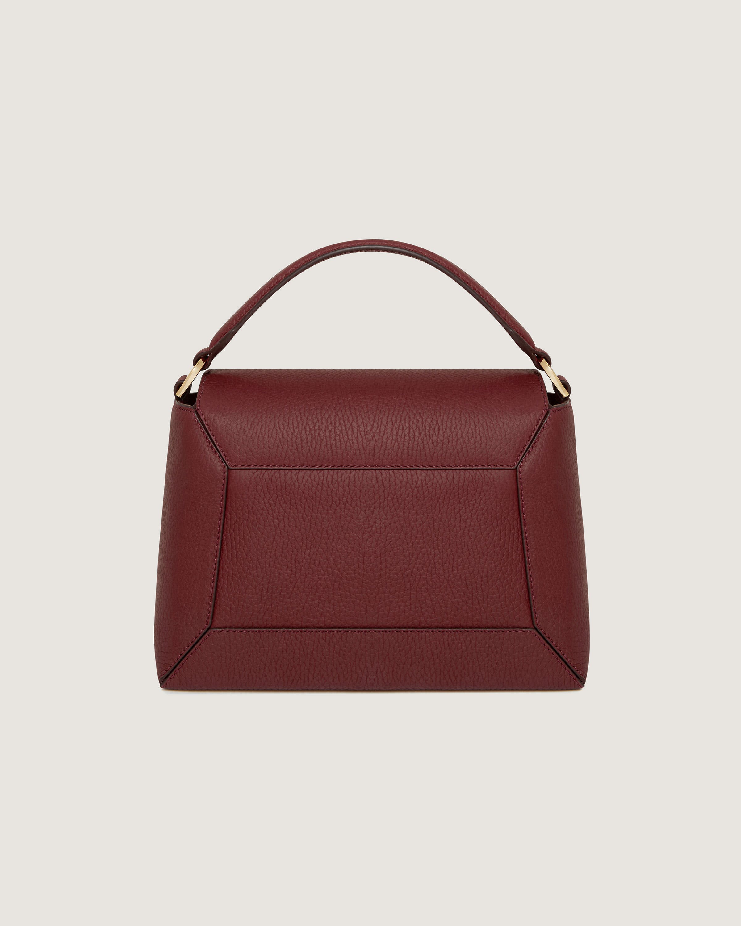 A red leather handbag with a gold handle