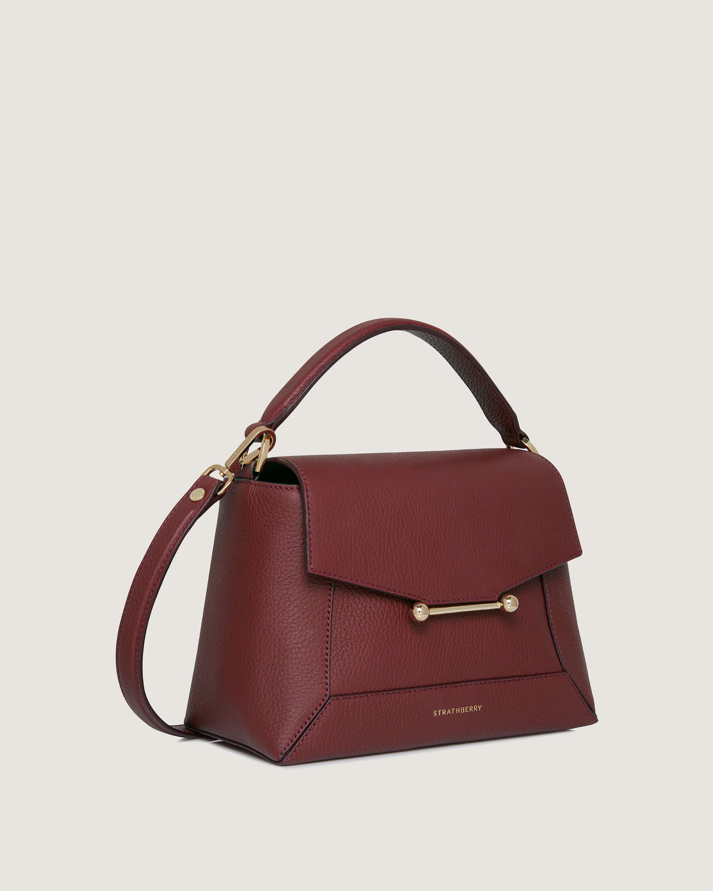 A red handbag with a gold handle