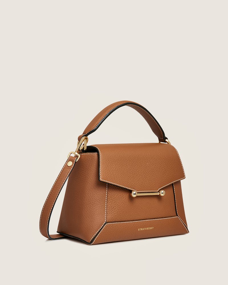 A brown handbag with a gold handle
