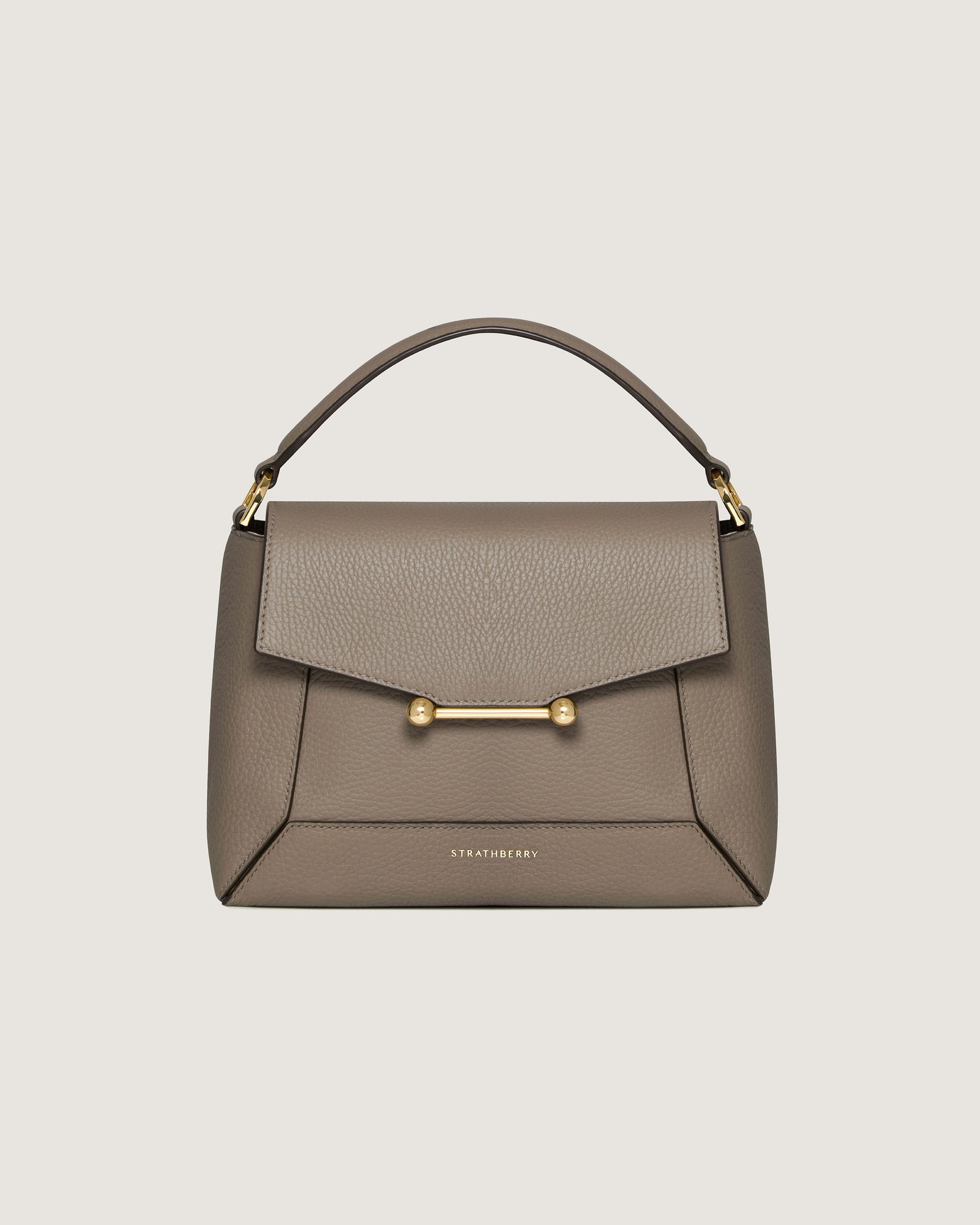 A grey handbag with a gold handle