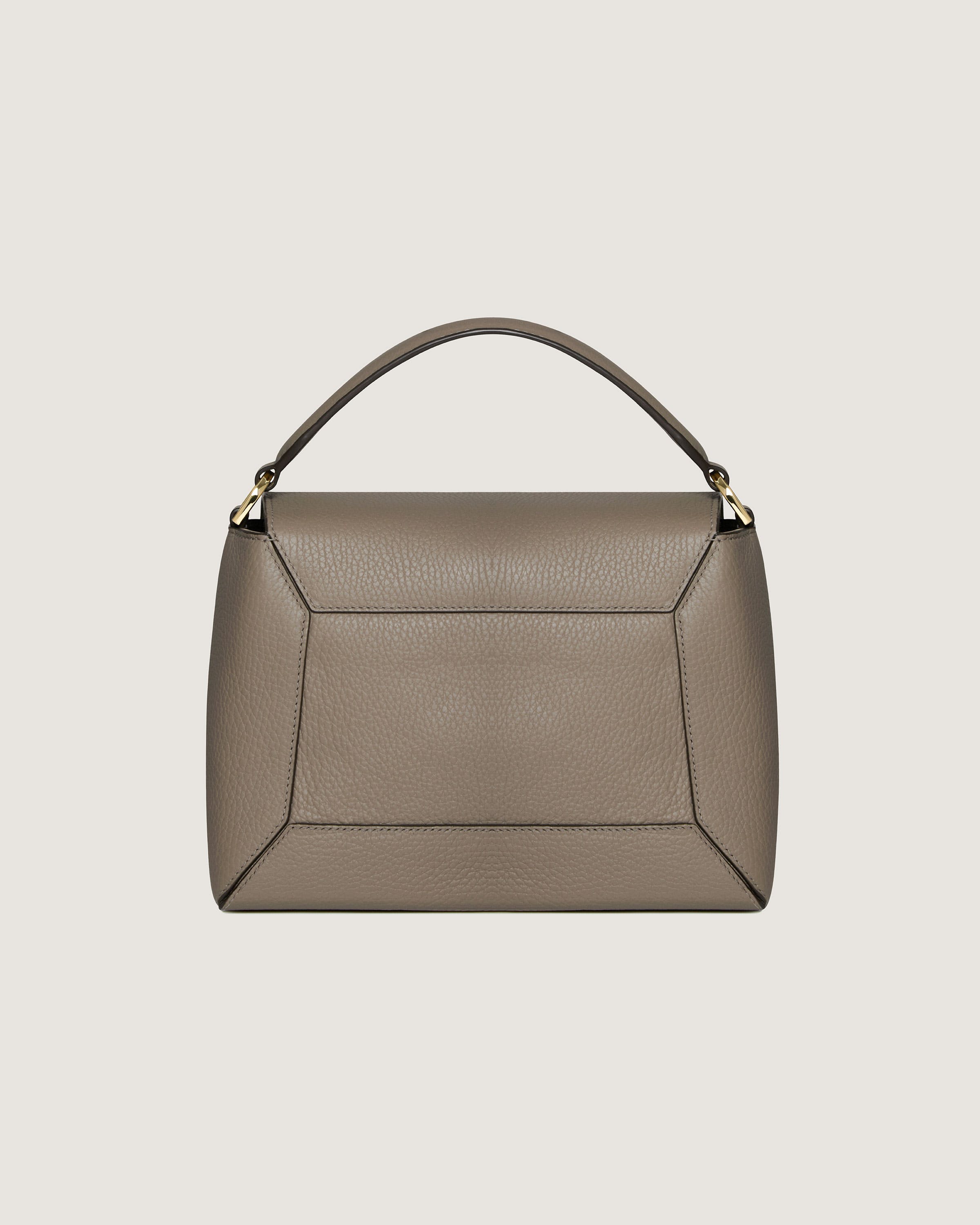 A grey leather handbag with a gold handle