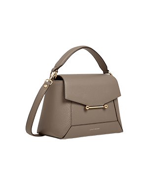 A grey handbag with a gold handle