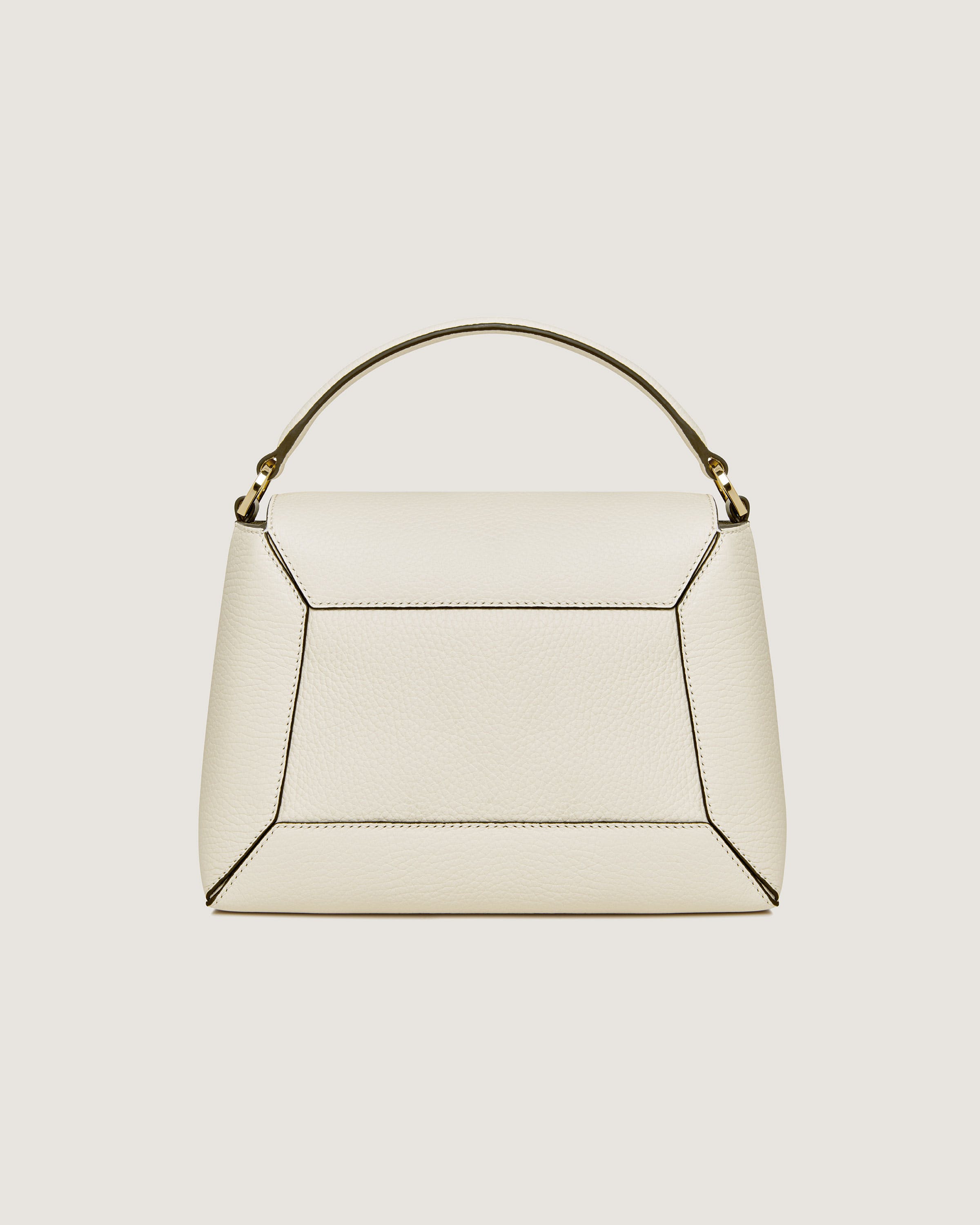 A white handbag with a curved handle