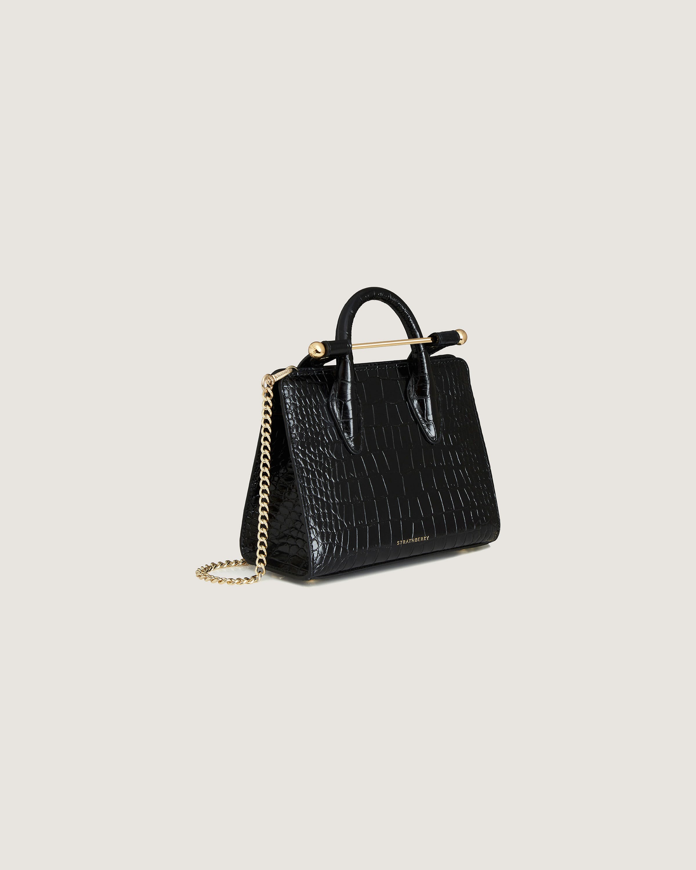 A black handbag with a gold chain