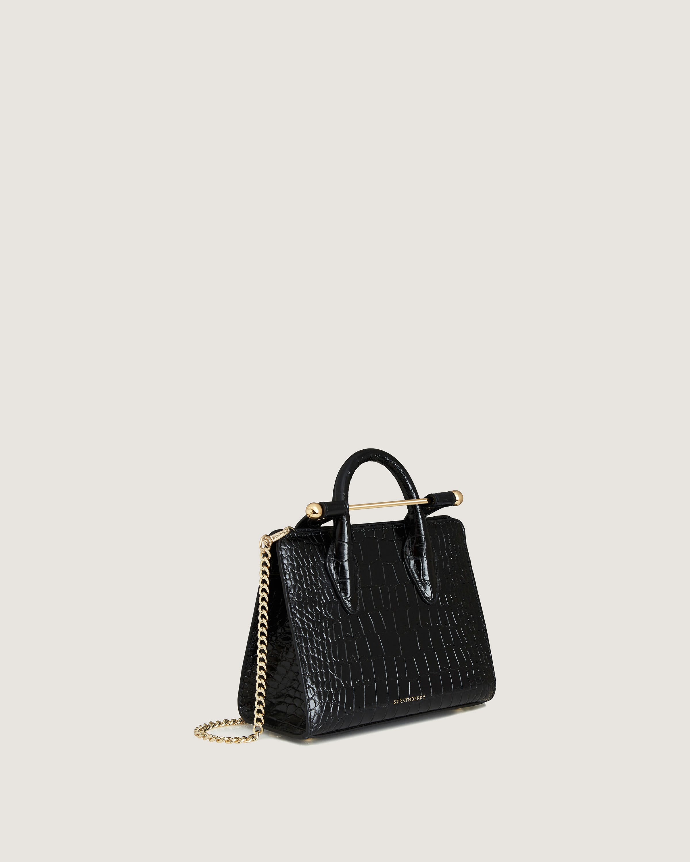 A black handbag with a gold chain