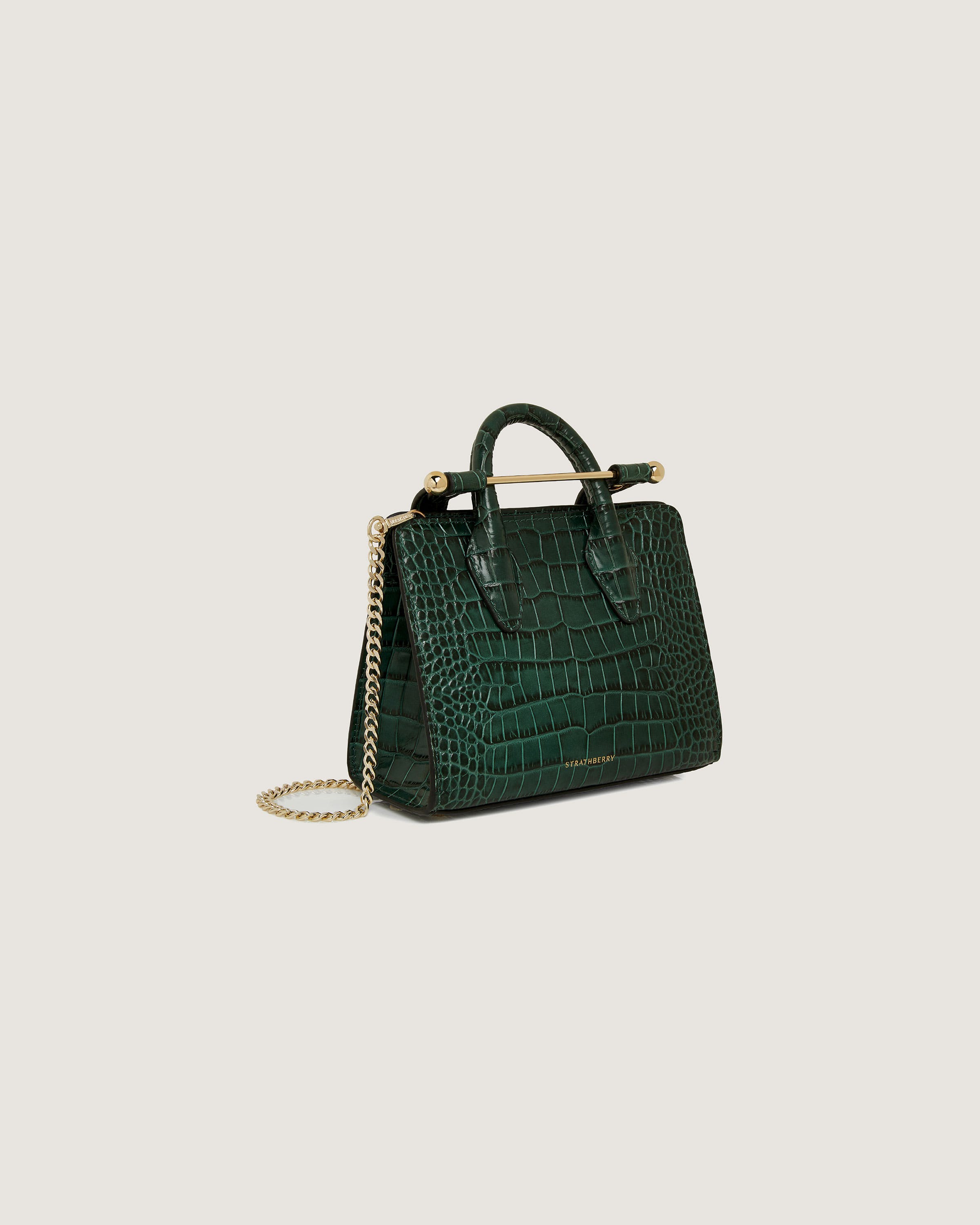 A green handbag on a white background