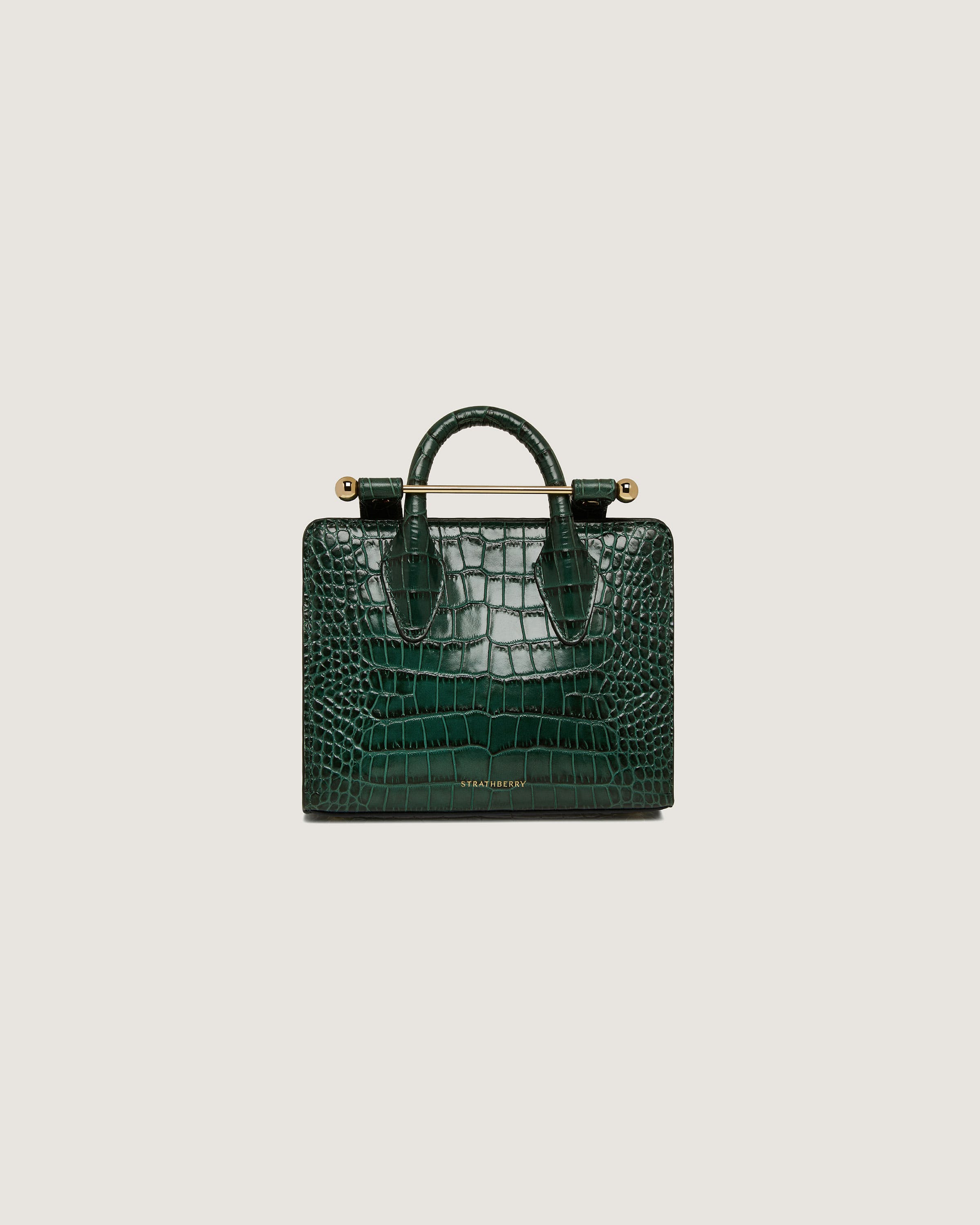 A green crocodile - embossed leather handbag