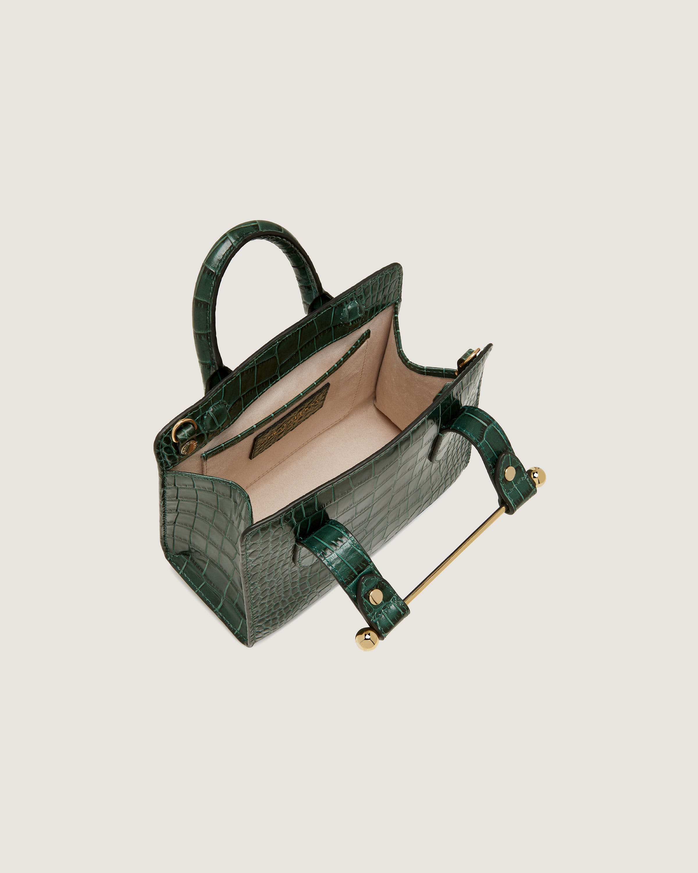 A green handbag with a gold handle