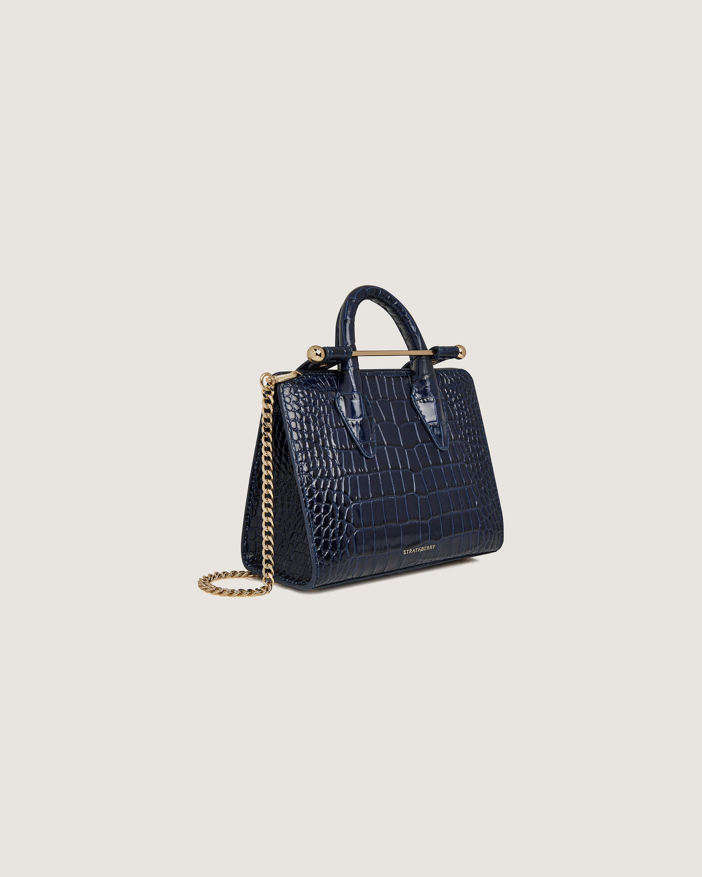 A small blue handbag with a gold chain