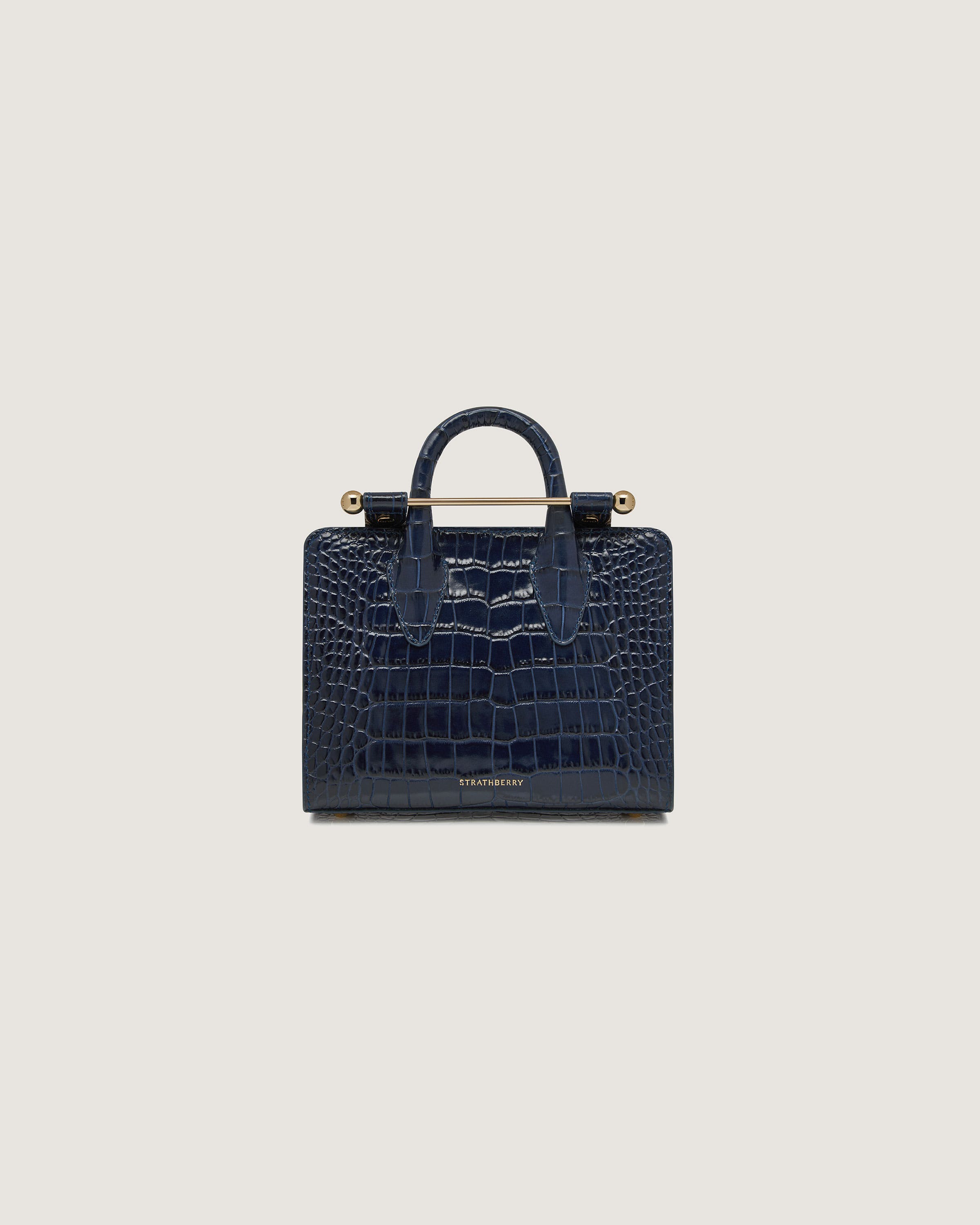 A small blue alligator - embossed leather bag