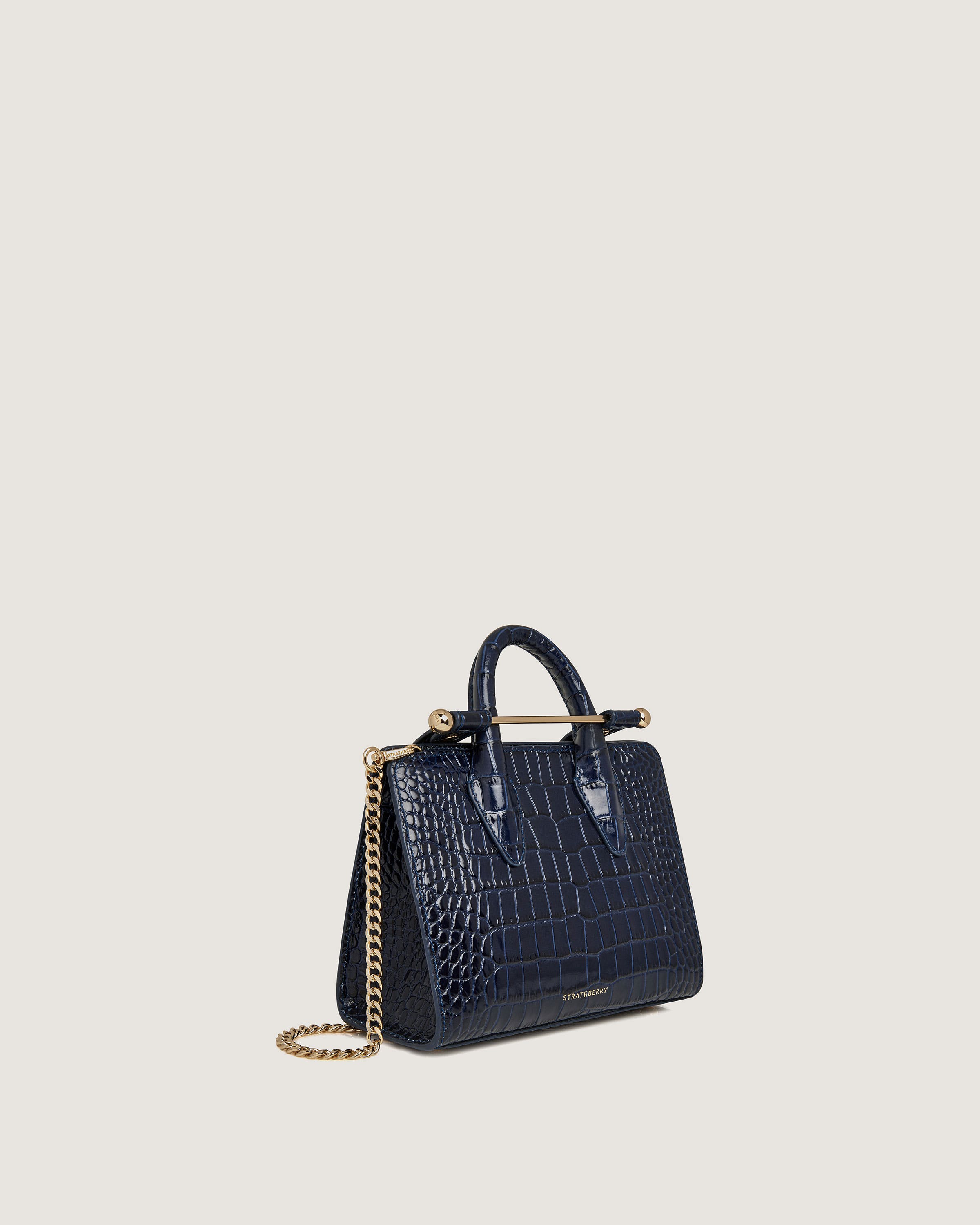 A small blue handbag with a gold chain